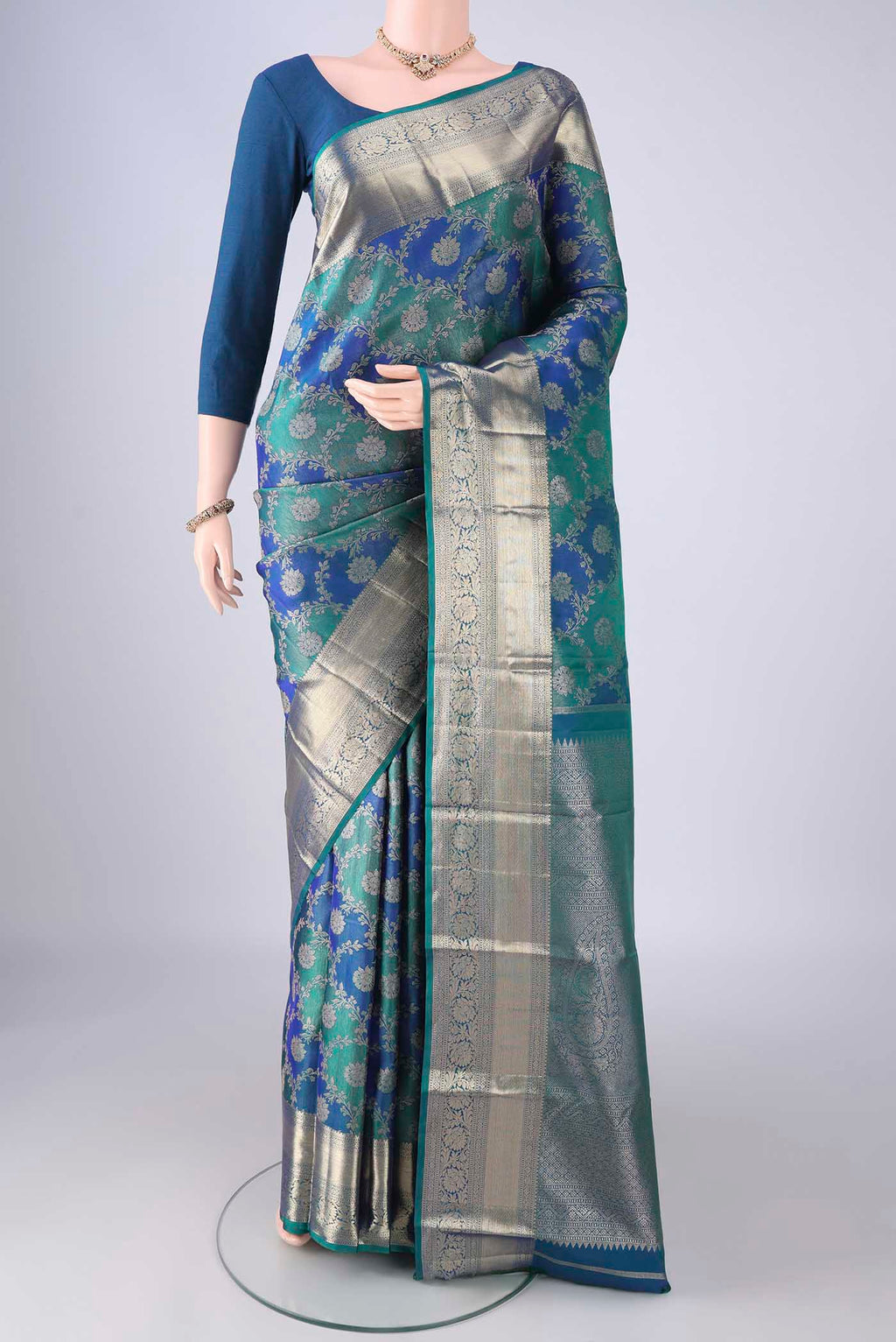 Peacock Blue Dual Tone Kanjivaram Silk Saree with Zari Brocade on the body and Zari Border.  displayed on a mannequin