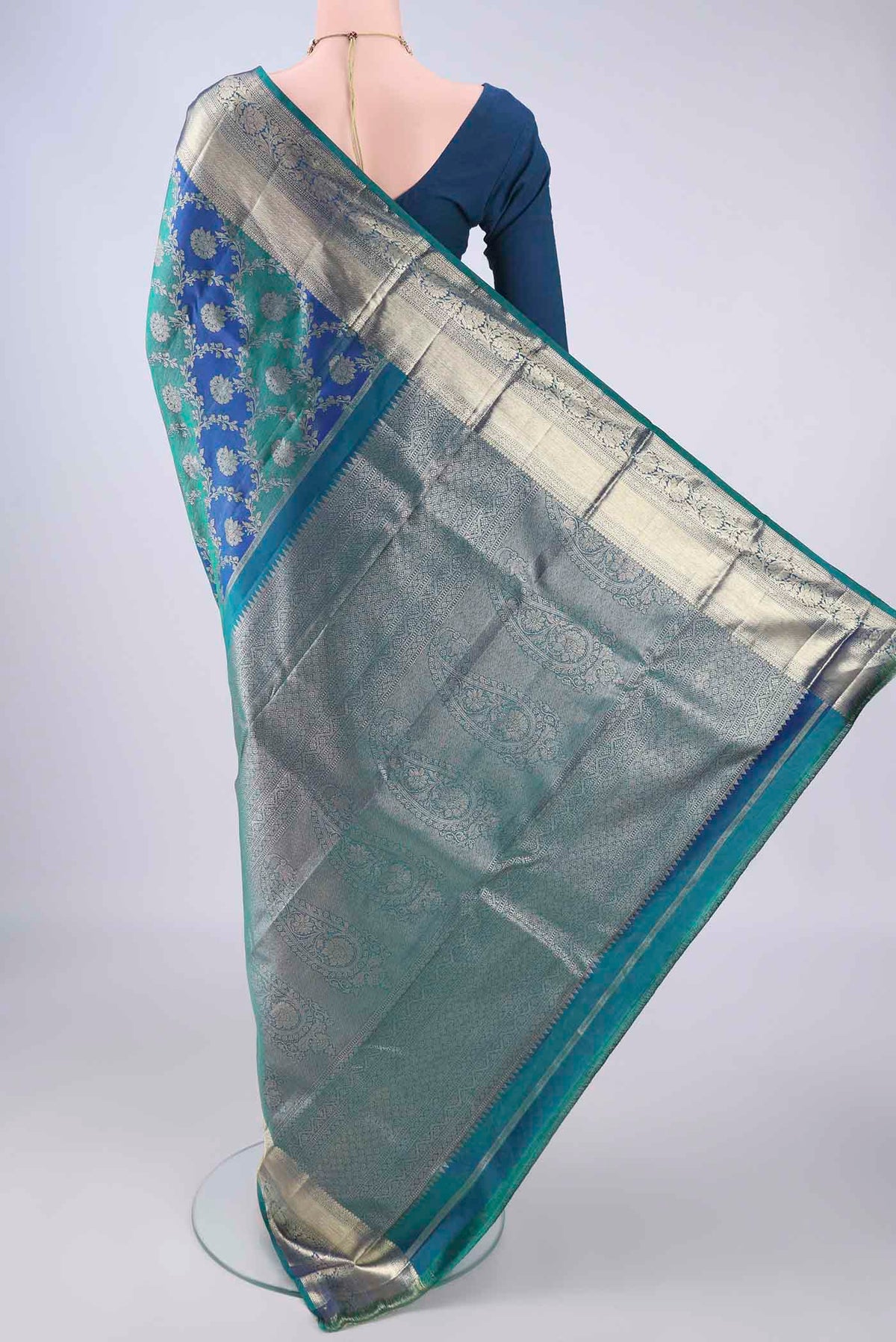 Flat view of Peacock Blue Dual Tone Kanjivaram Silk Saree with Zari Brocade on the body and Zari Border. 