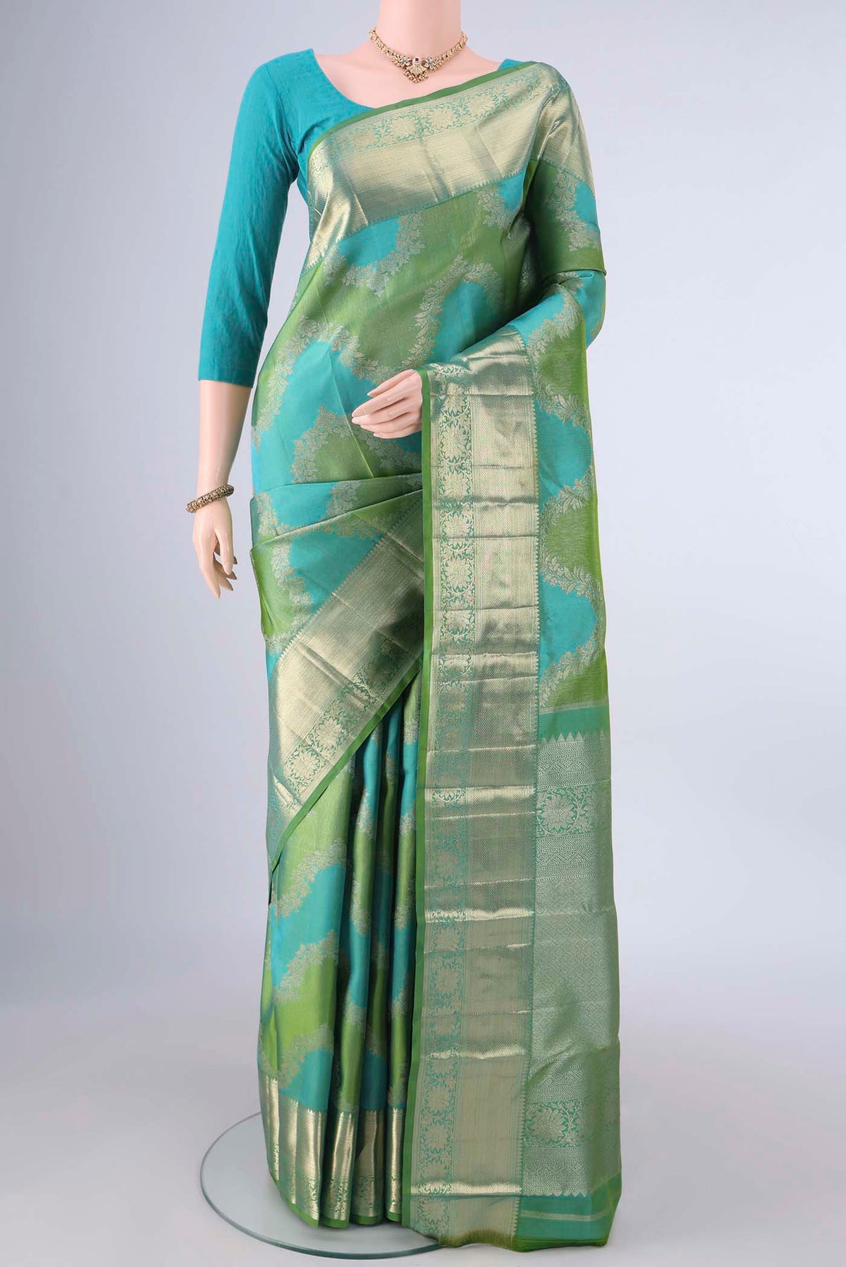 Pure Silk Multi Color Kanjivaram Saree with Zari Butta on the body and Zari Border.  displayed on a mannequin