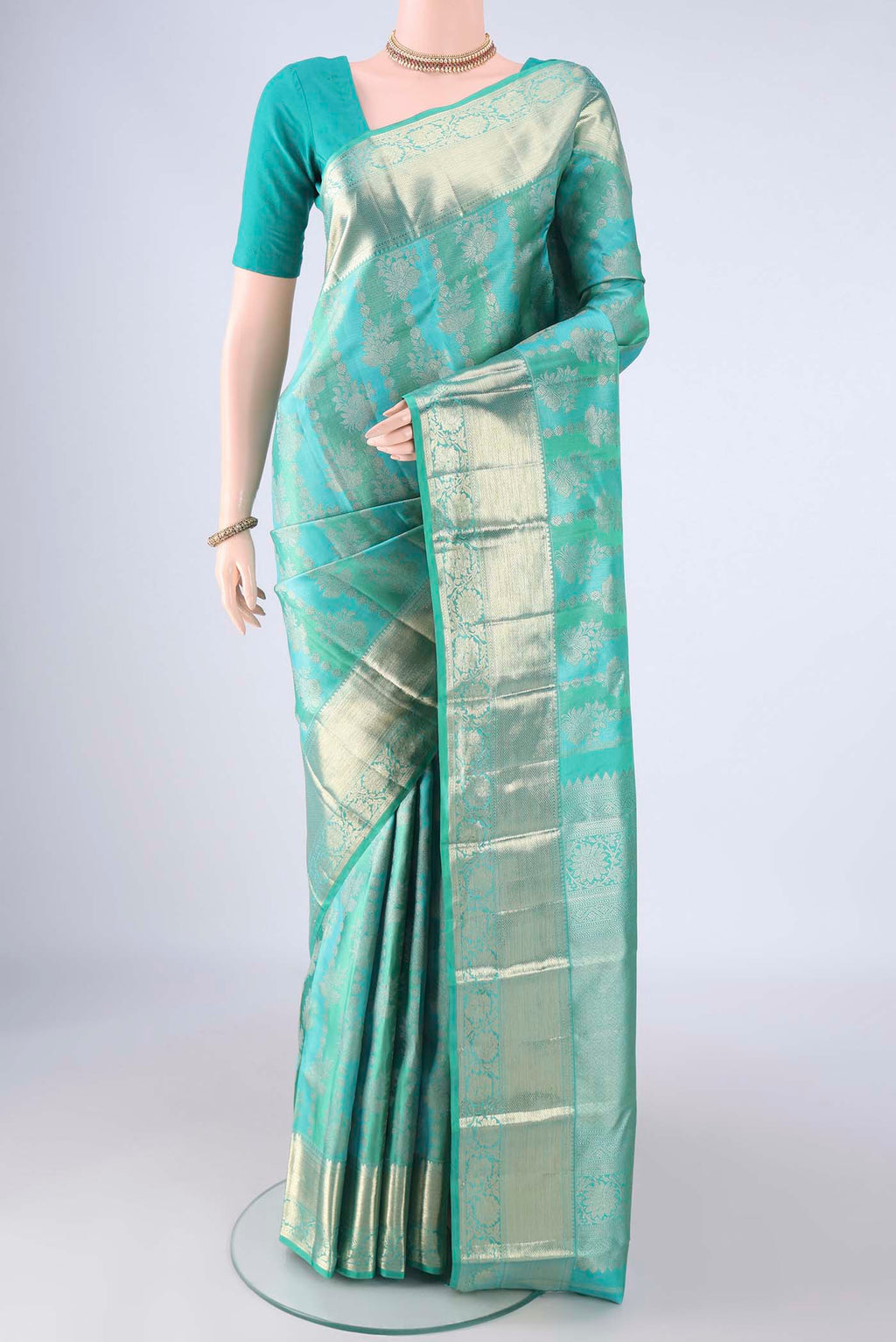 Turquoise Kanjivaram Silk Saree with Zari Brocade on the body and Zari Border.  displayed on a mannequin