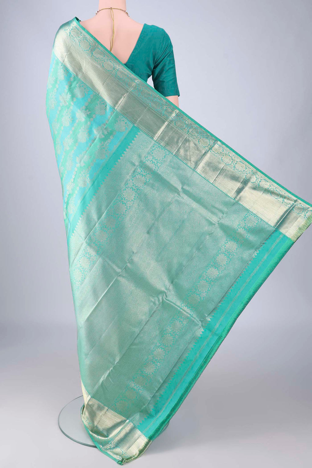 Flat view of Turquoise Kanjivaram Silk Saree with Zari Brocade on the body and Zari Border. 