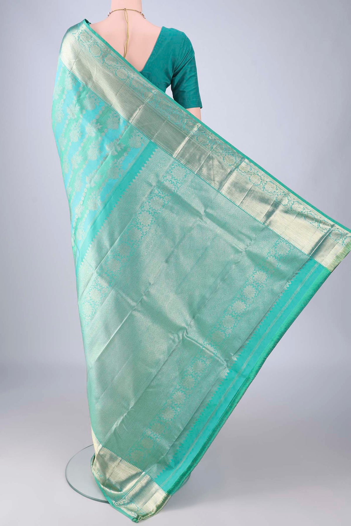 Flat view of Turquoise Kanjivaram Silk Saree with Zari Brocade on the body and Zari Border. 