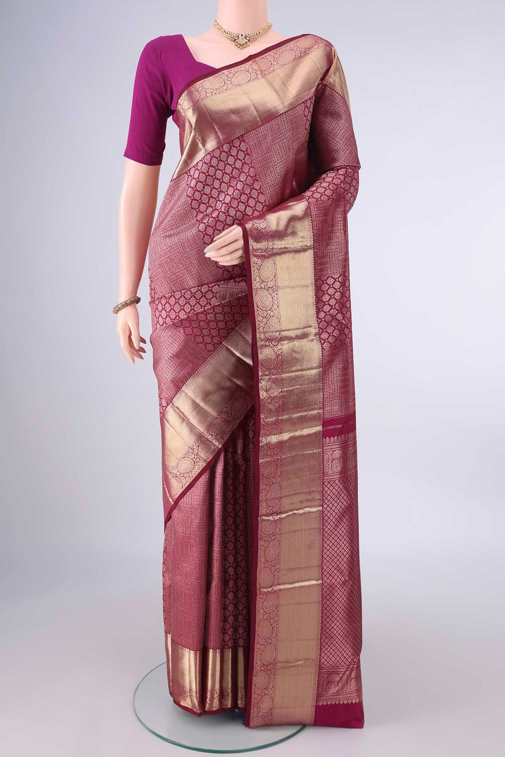 Pure Silk Maroon Kanjivaram Saree with Zari Brocade on the body and Zari Border.  displayed on a mannequin