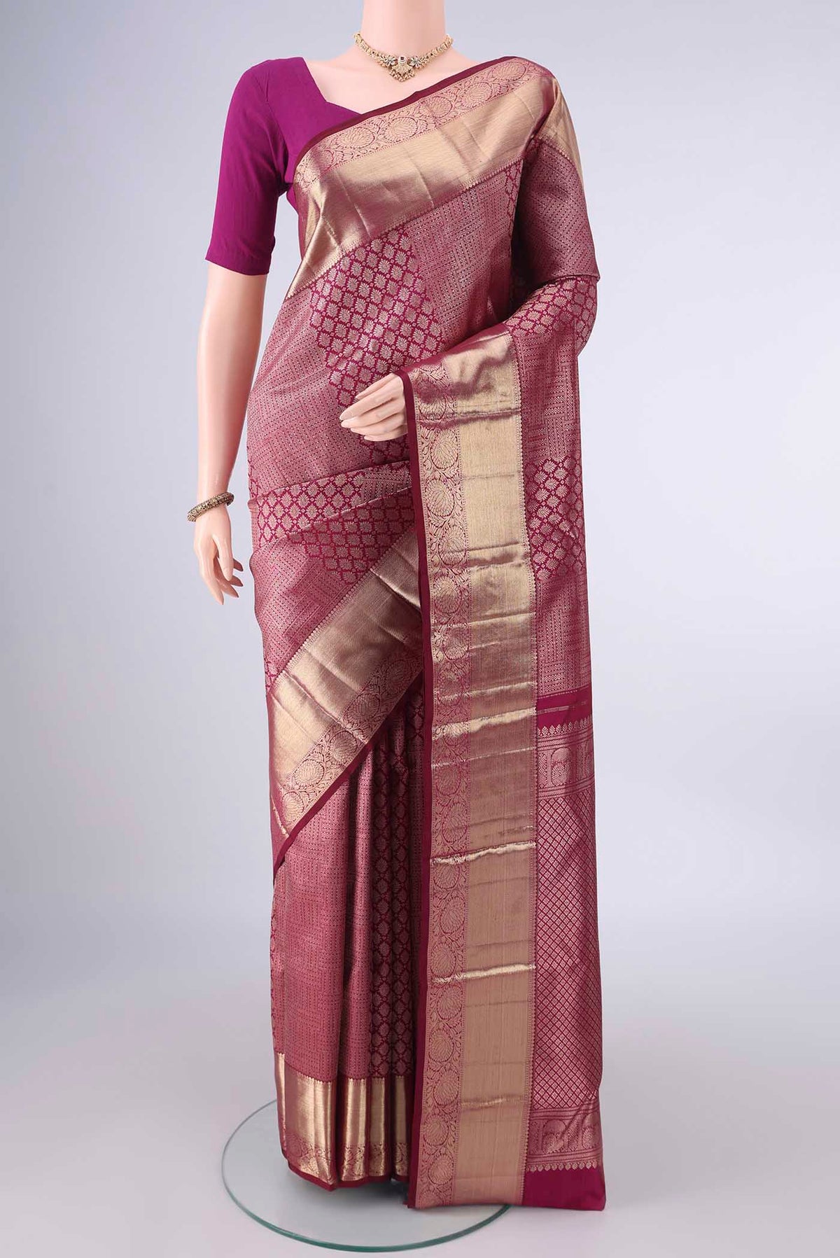 Pure Silk Maroon Kanjivaram Saree with Zari Brocade on the body and Zari Border.  displayed on a mannequin