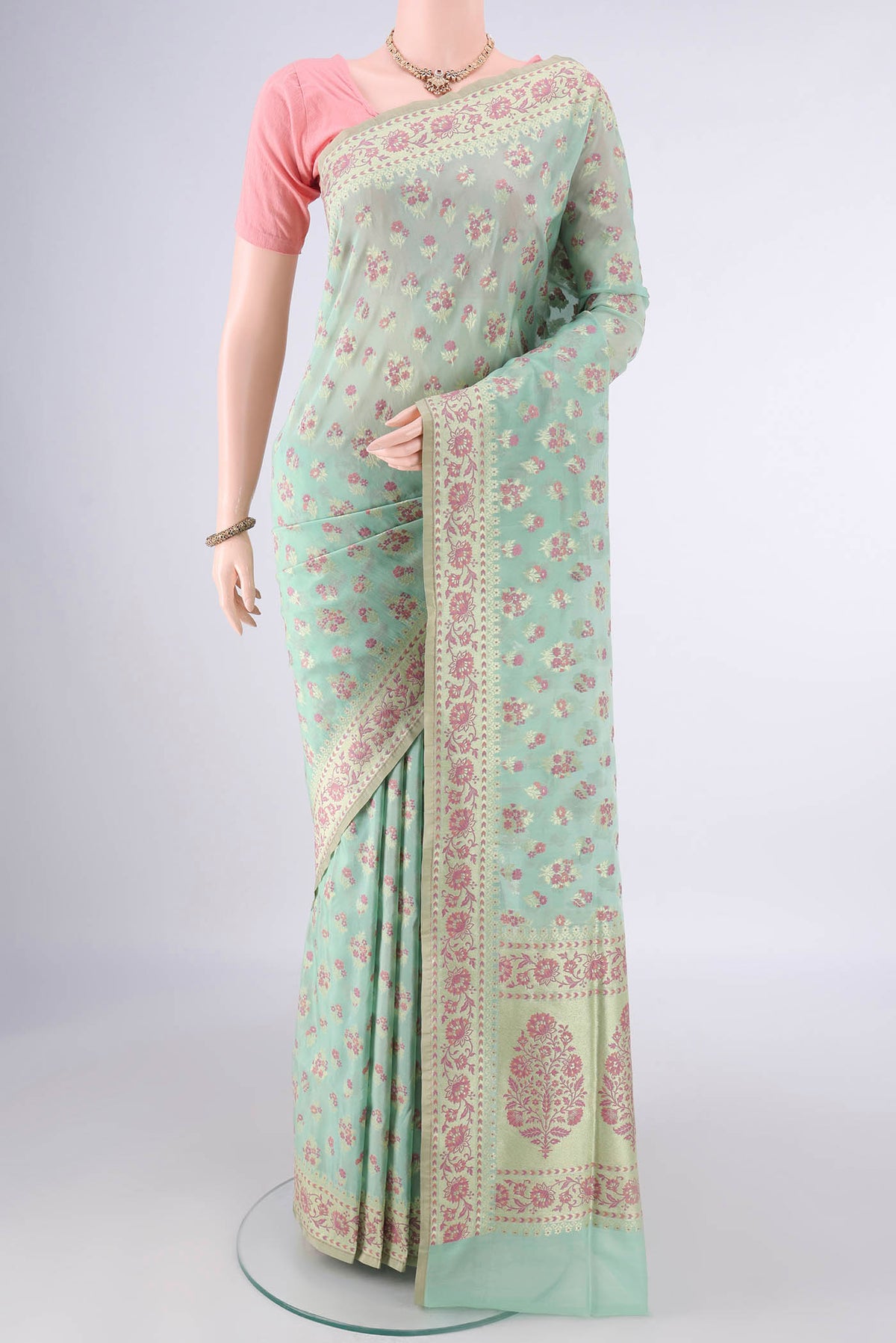 Pure Silk Light Green Banarasi Saree with Zari And Thread Butta on the body and Zari Border.  displayed on a mannequin