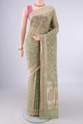 Light Green Banarasi Saree with Zari And Thread Butta on the body and Zari And Thread Border.  displayed on a mannequin