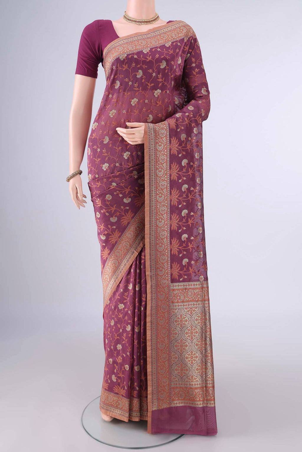 Pure Silk Mauve Banarasi Saree with Thread Butta on the body and Zari And Thread Border.  displayed on a mannequin