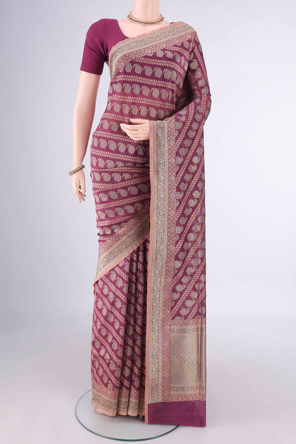 Pure Silk Dark Mauve Banarasi Saree with Zari And Thread Butta on the body and Zari Border.  displayed on a mannequin