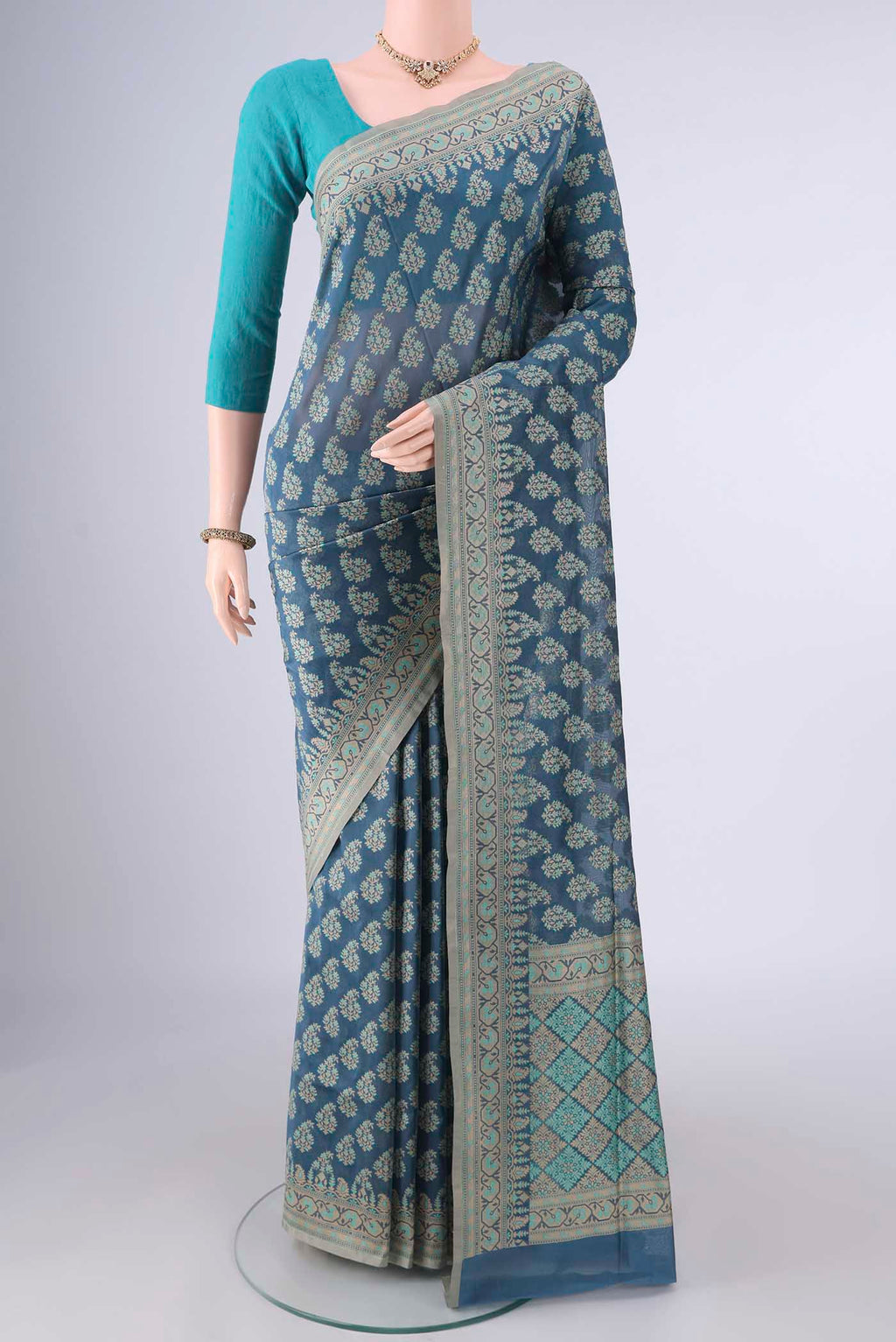 Pure Silk Maya Blue Banarasi Saree with Thread Butta on the body and Thread Border.  displayed on a mannequin