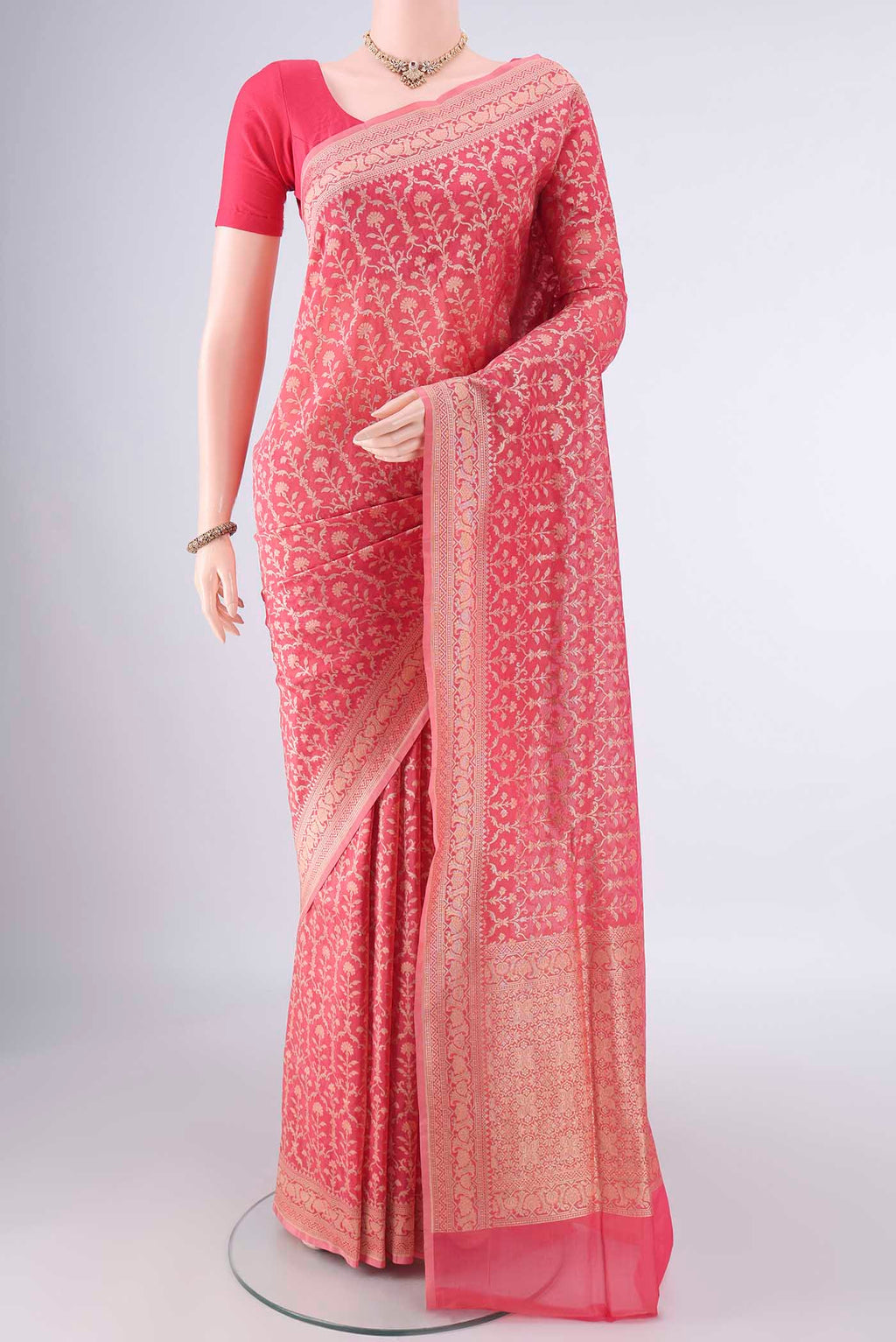 Pure Silk Peach Banarasi Saree with Zari And Thread Butta on the body and Zari Border.  displayed on a mannequin