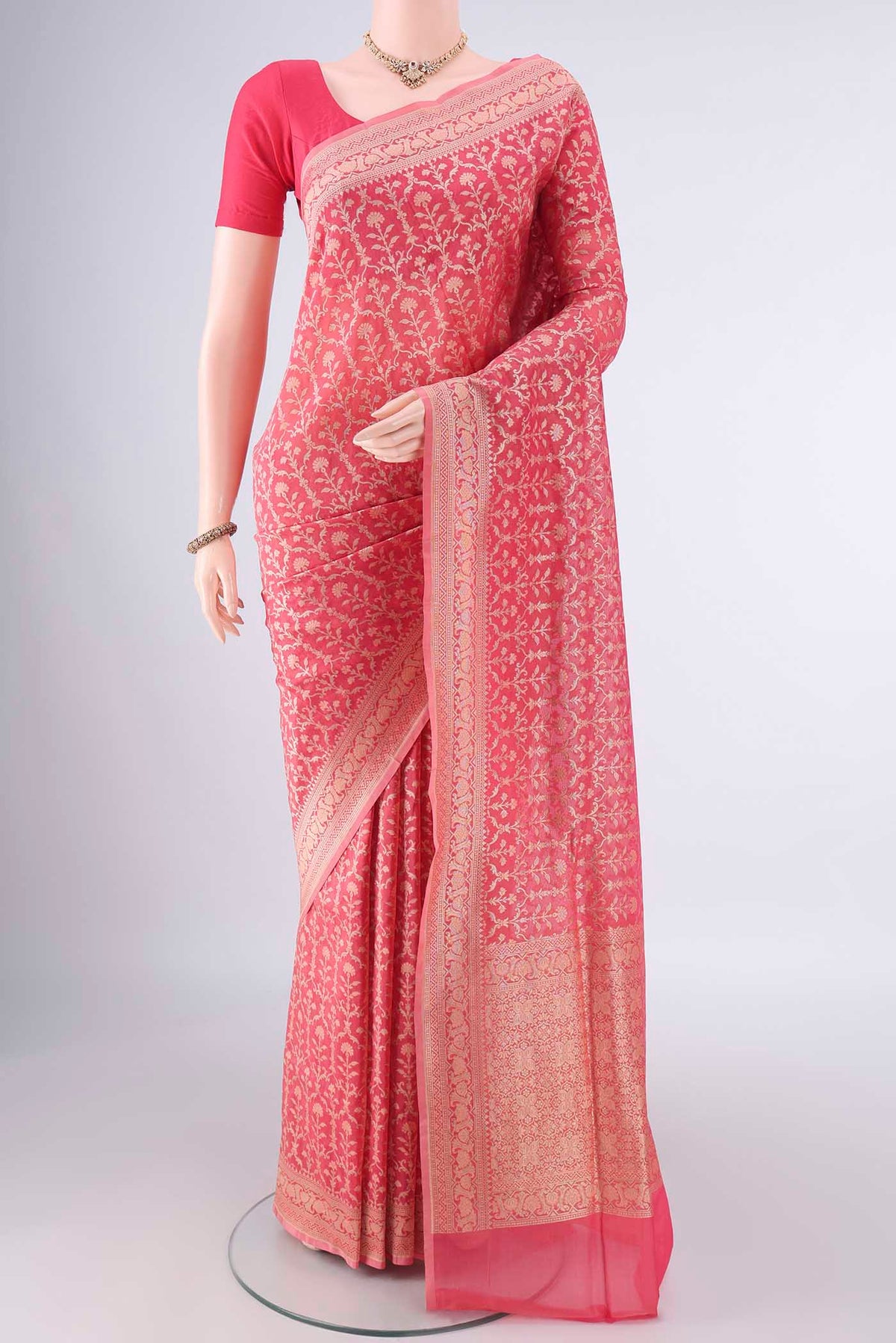 Pure Silk Peach Banarasi Saree with Zari And Thread Butta on the body and Zari Border.  displayed on a mannequin