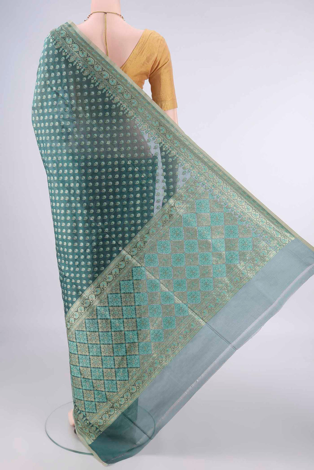 Flat view of Pure Silk Teal Banarasi Saree with Zari Butta on the body and Zari Border. 