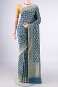 Pure Silk Teal Banarasi Saree with Zari And Thread Butta on the body and Zari Border.  displayed on a mannequin