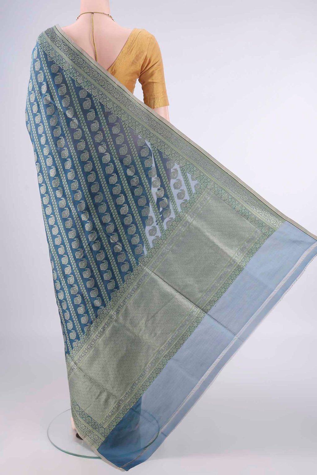 Flat view of Pure Silk Teal Banarasi Saree with Zari And Thread Butta on the body and Zari Border. 