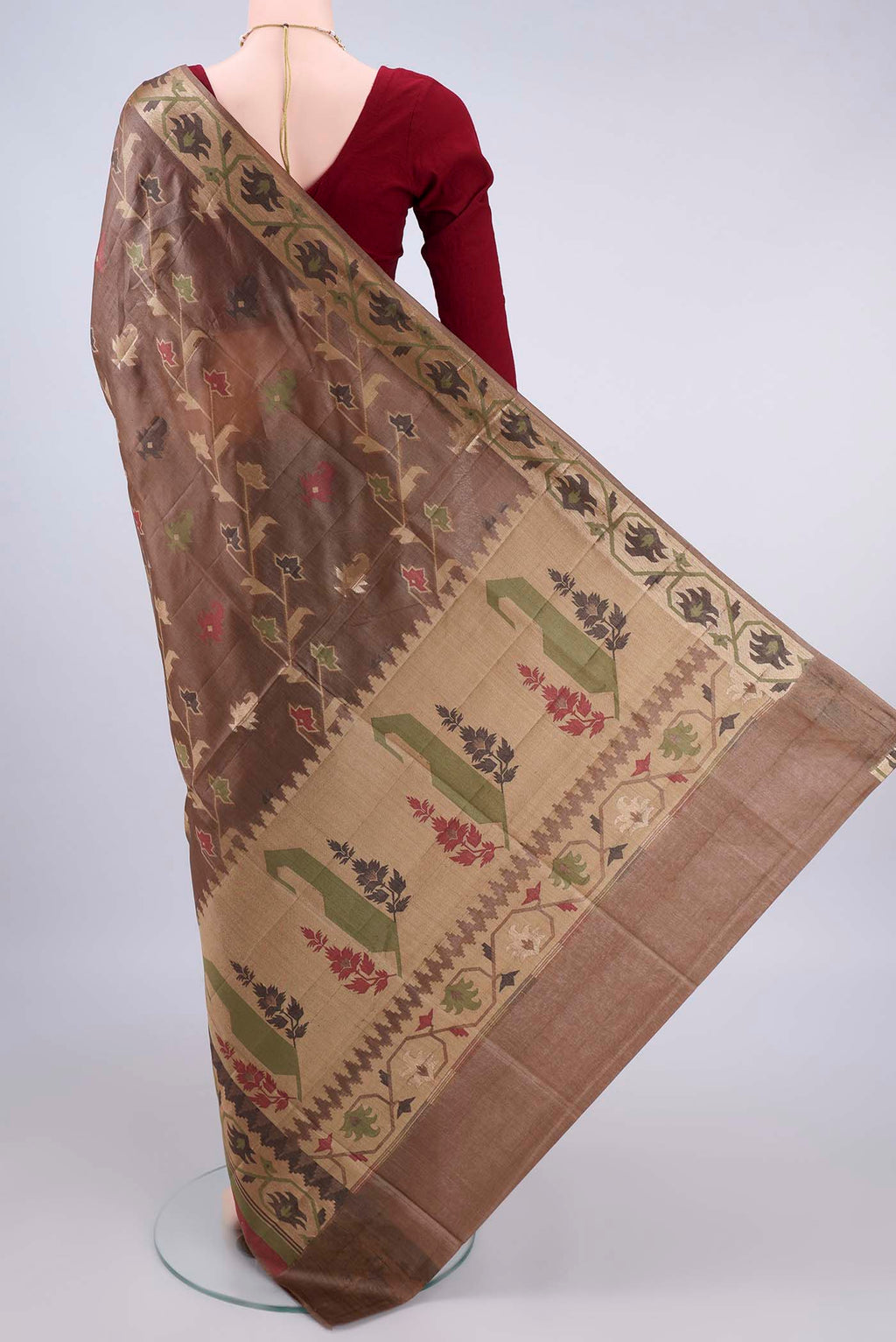Flat view of Brown Banarasi Tussar Saree with Zari And Thread Butta on the body and Thread Border. 