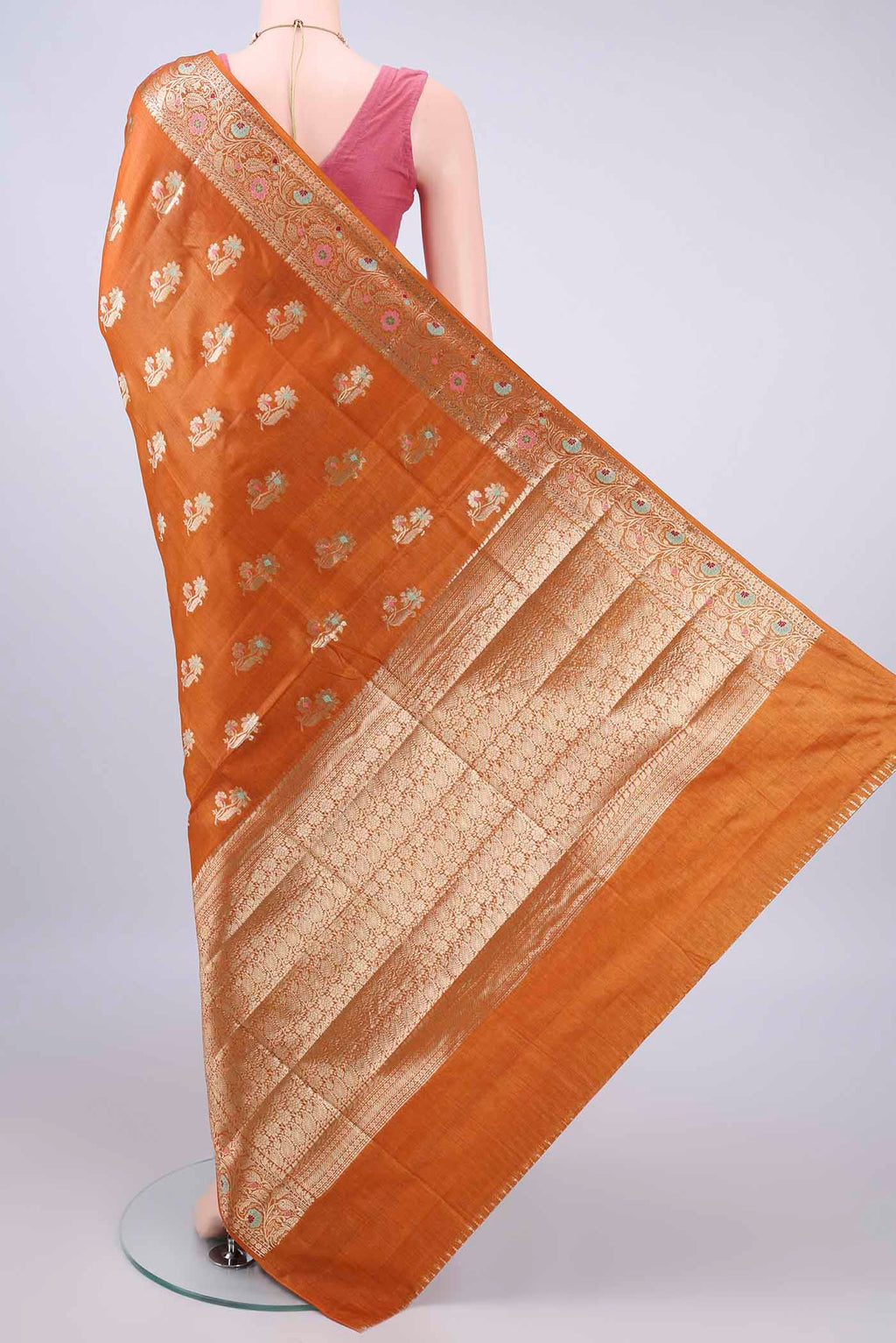 Flat view of Rust Banarasi Tussar Saree with Zari And Thread Butta on the body and Zari Border. 