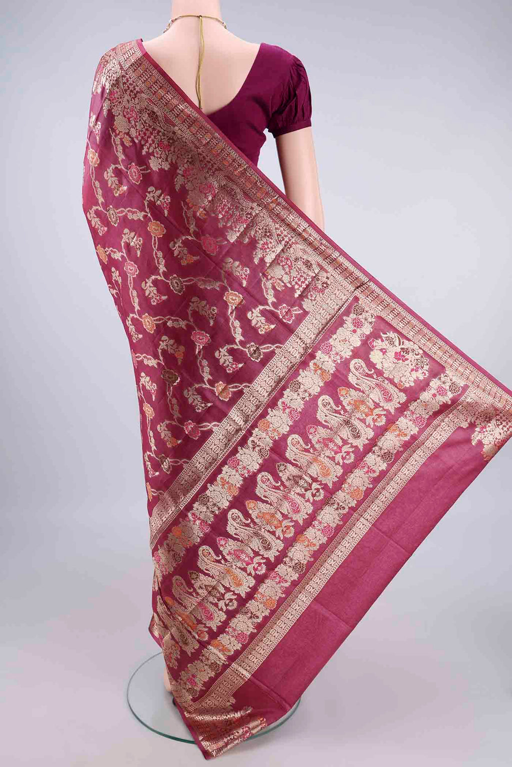 Flat view of Dark Pink Banarasi Tussar Saree with Zari And Thread Butta on the body and Zari Border. 