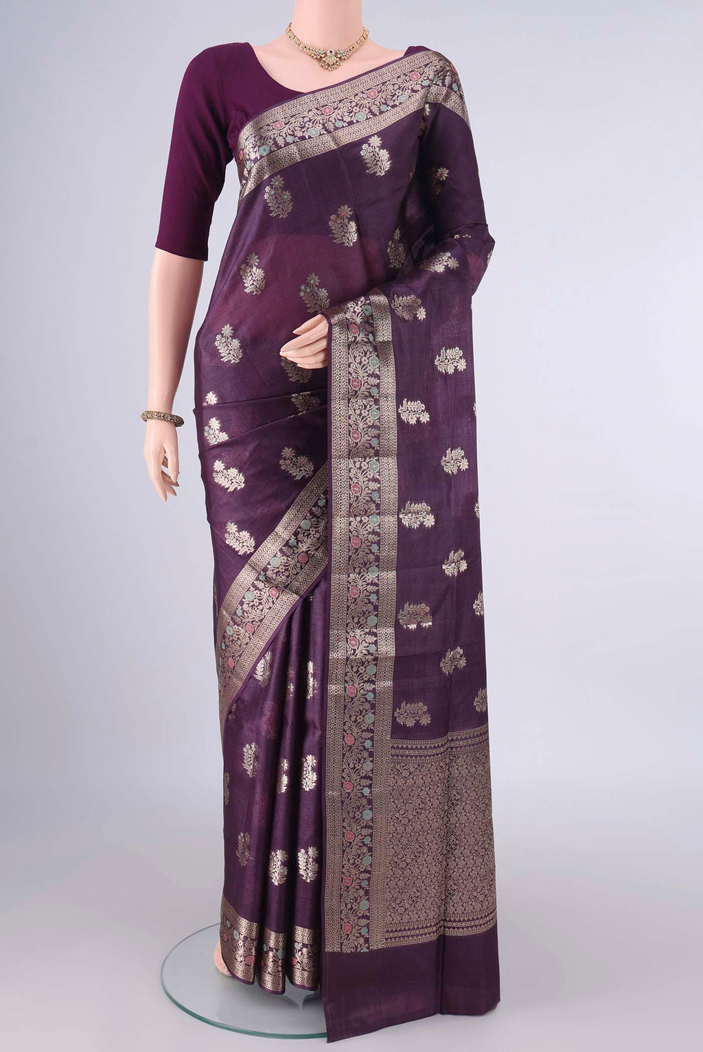 Purple Banarasi Tussar Saree with Zari And Thread Butta on the body and Zari Border.  displayed on a mannequin