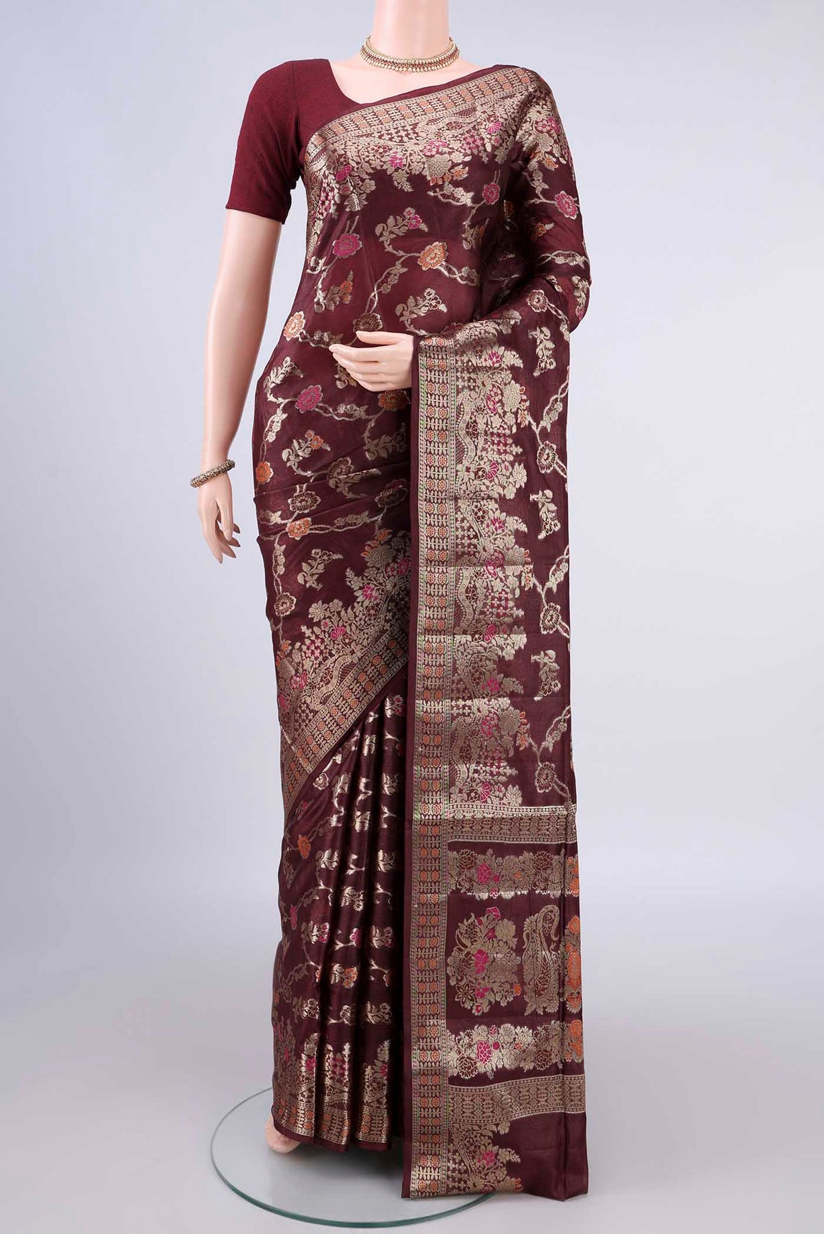 Coffee Brown Banarasi Tussar Saree with Zari And Thread Butta on the body and Zari Border.  displayed on a mannequin
