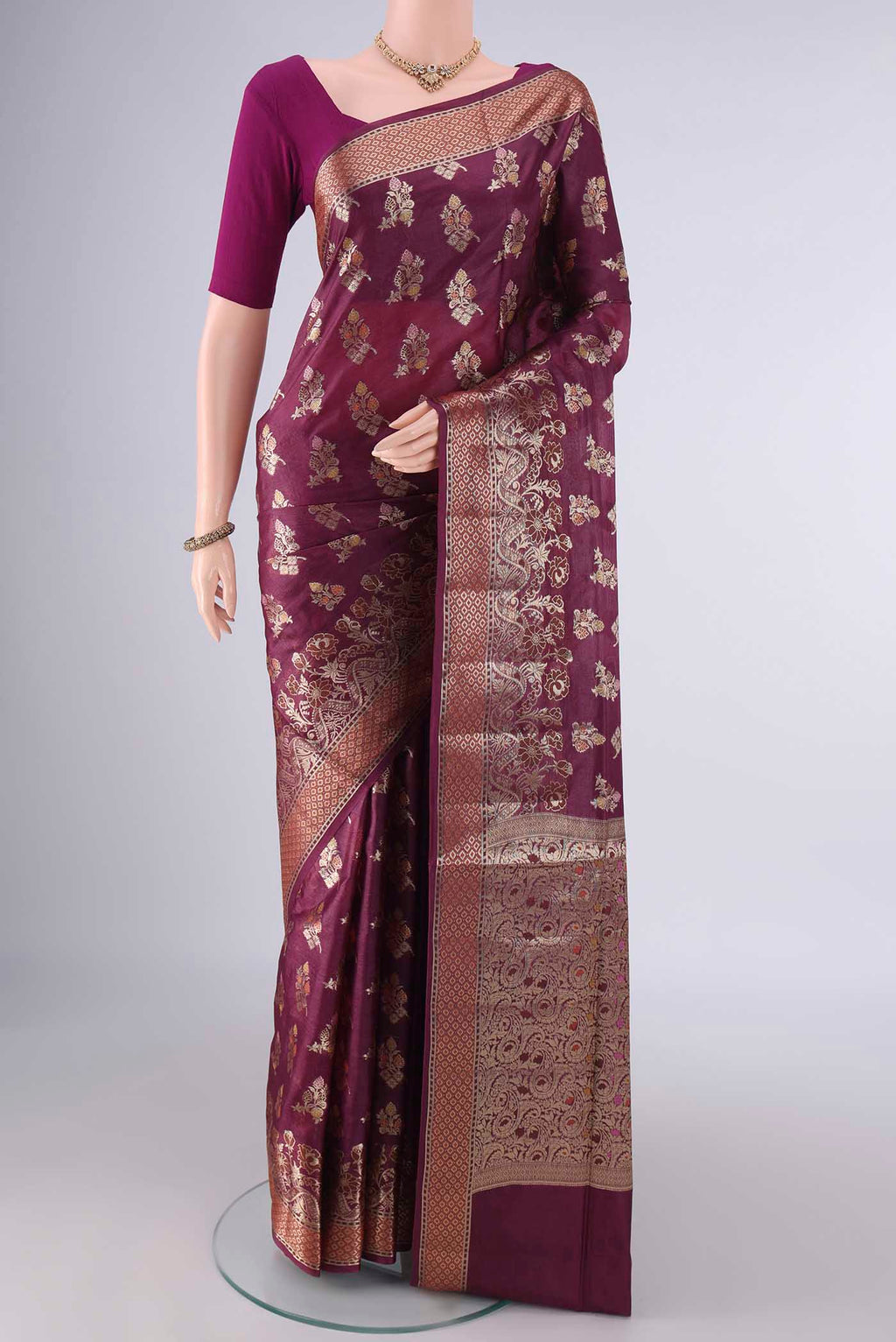 Burgundy Banarasi Tussar Saree with Zari And Thread Butta on the body and Zari Border.  displayed on a mannequin