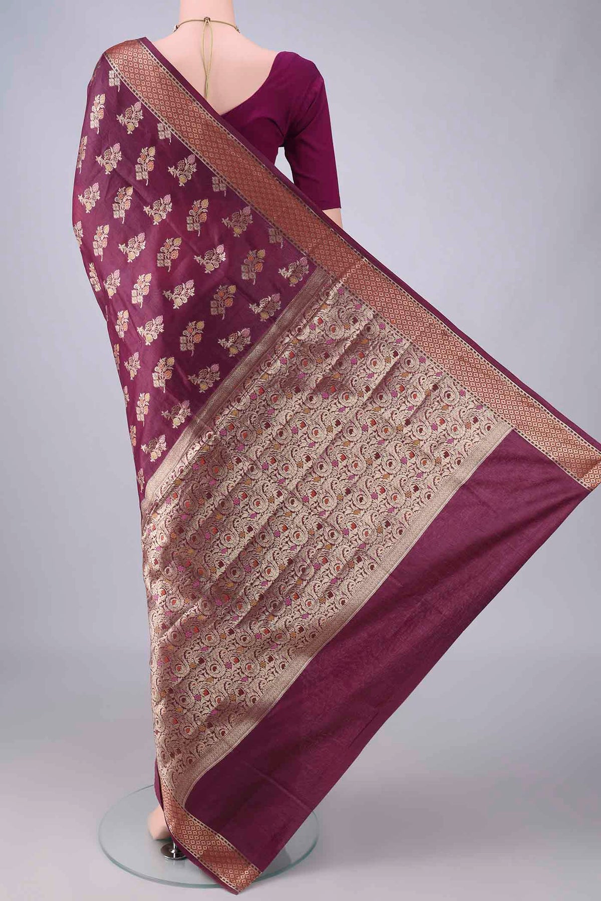 Flat view of Burgundy Banarasi Tussar Saree with Zari And Thread Butta on the body and Zari Border. 