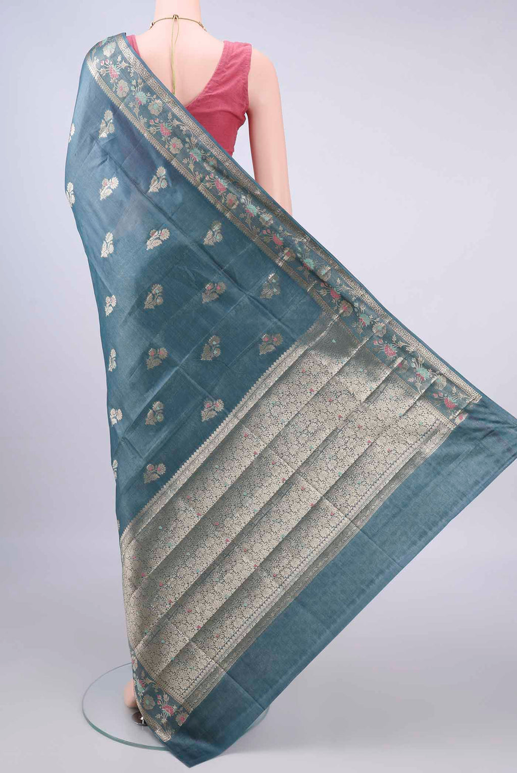 Flat view of Blue Grey Banarasi Tussar Saree with Zari And Thread Butta on the body and Zari Border. 