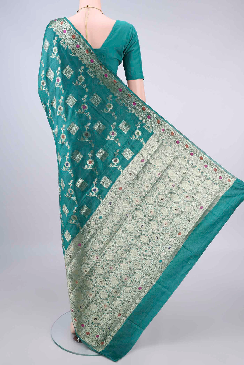 Flat view of Sea Green Banarasi Tussar Saree with Zari And Thread Butta on the body and Zari Border. 