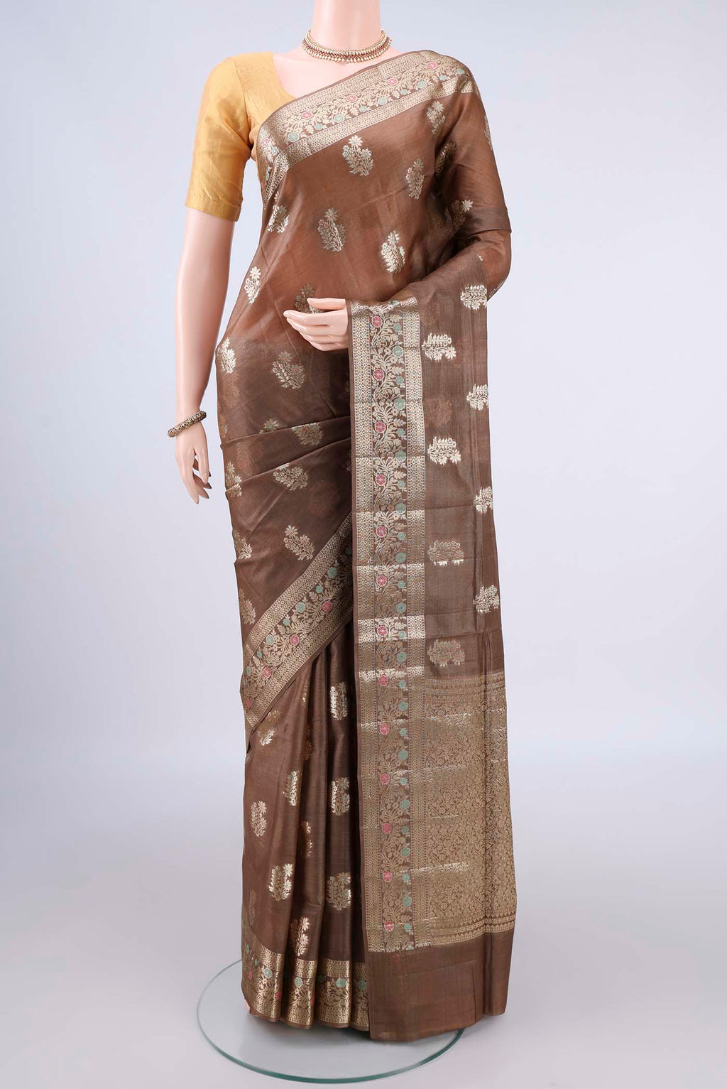 Brown Banarasi Tussar Saree with Zari And Thread Butta on the body and Zari Border.  displayed on a mannequin