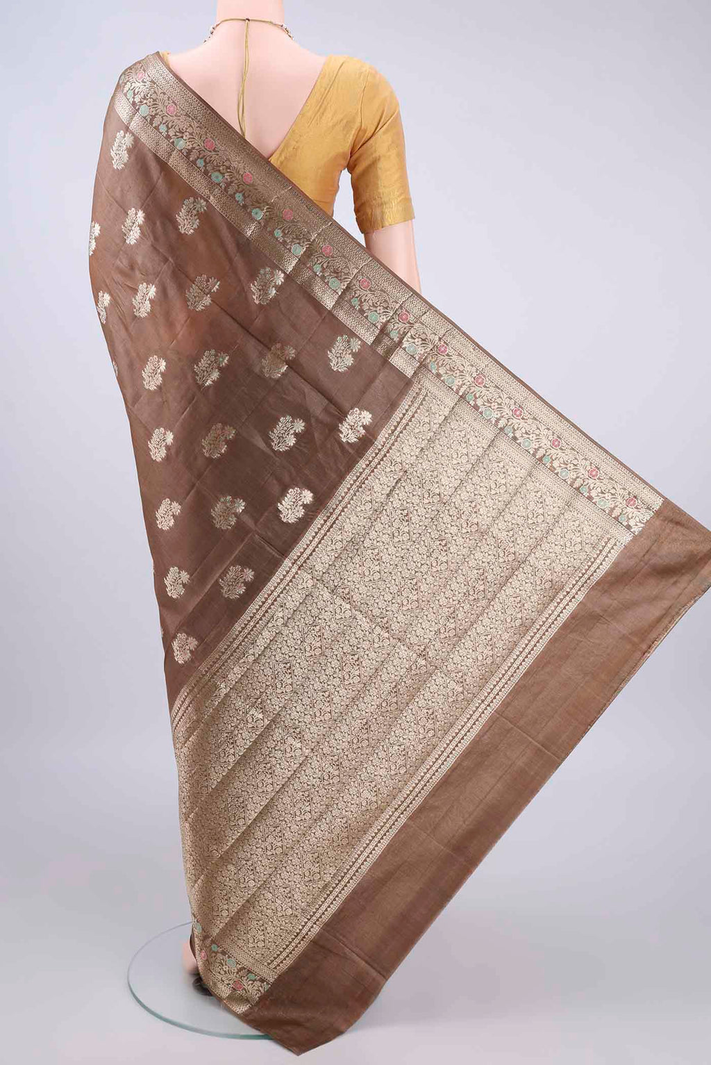 Flat view of Brown Banarasi Tussar Saree with Zari And Thread Butta on the body and Zari Border. 