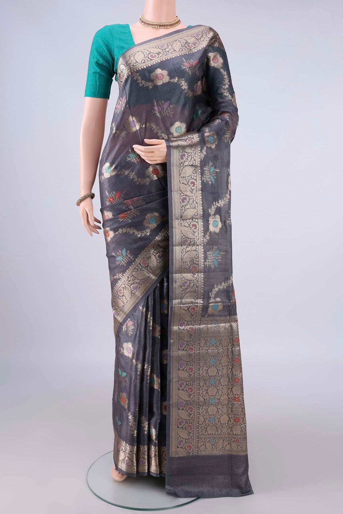 Pure Silk Davys Grey Banarasi Tussar Saree with Zari And Thread Butta on the body and Zari And Thread Border.  displayed on a mannequin