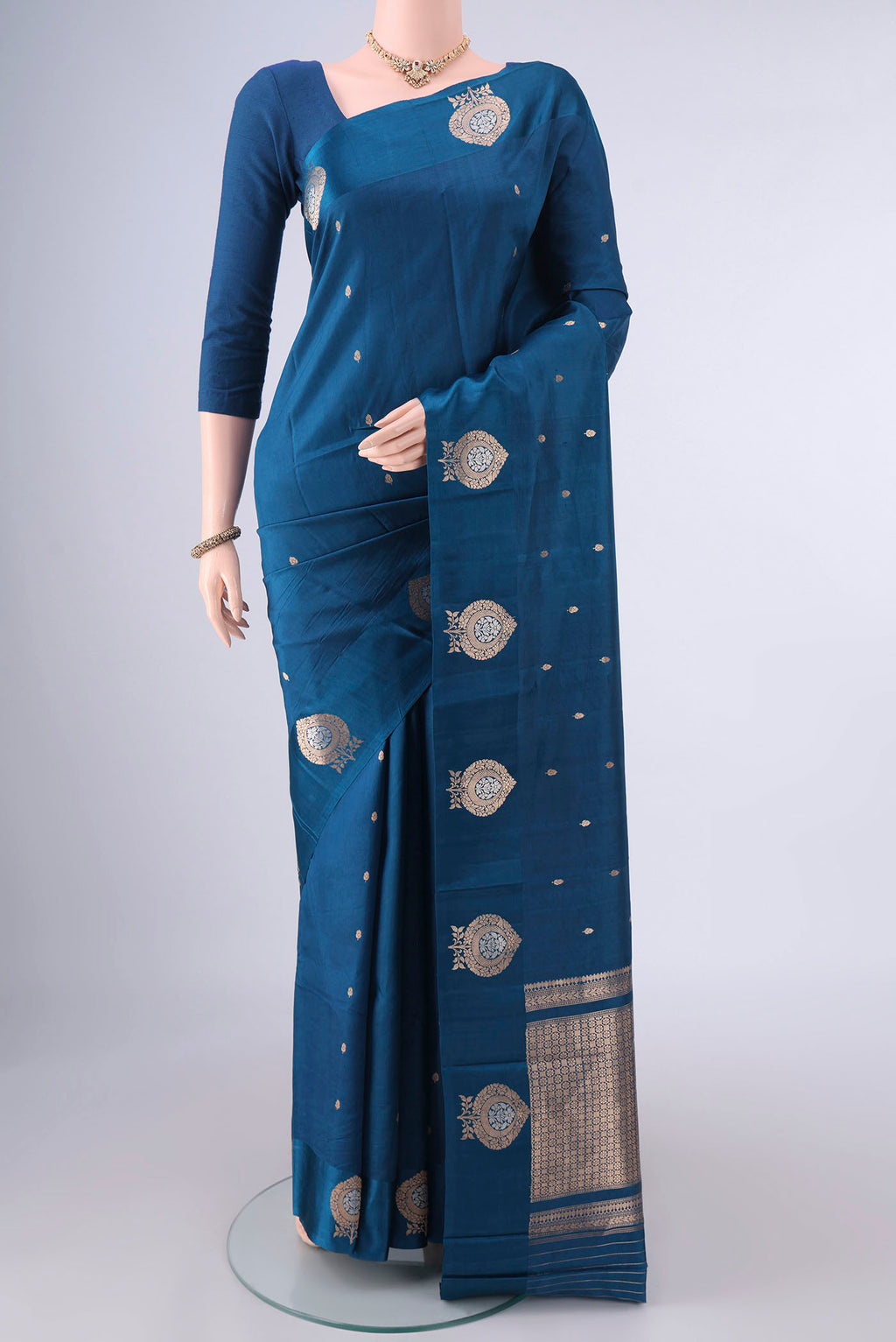 Pure Silk Blue Banarasi Katan Saree with Zari Butta on the body and Satin Border.  displayed on a mannequin