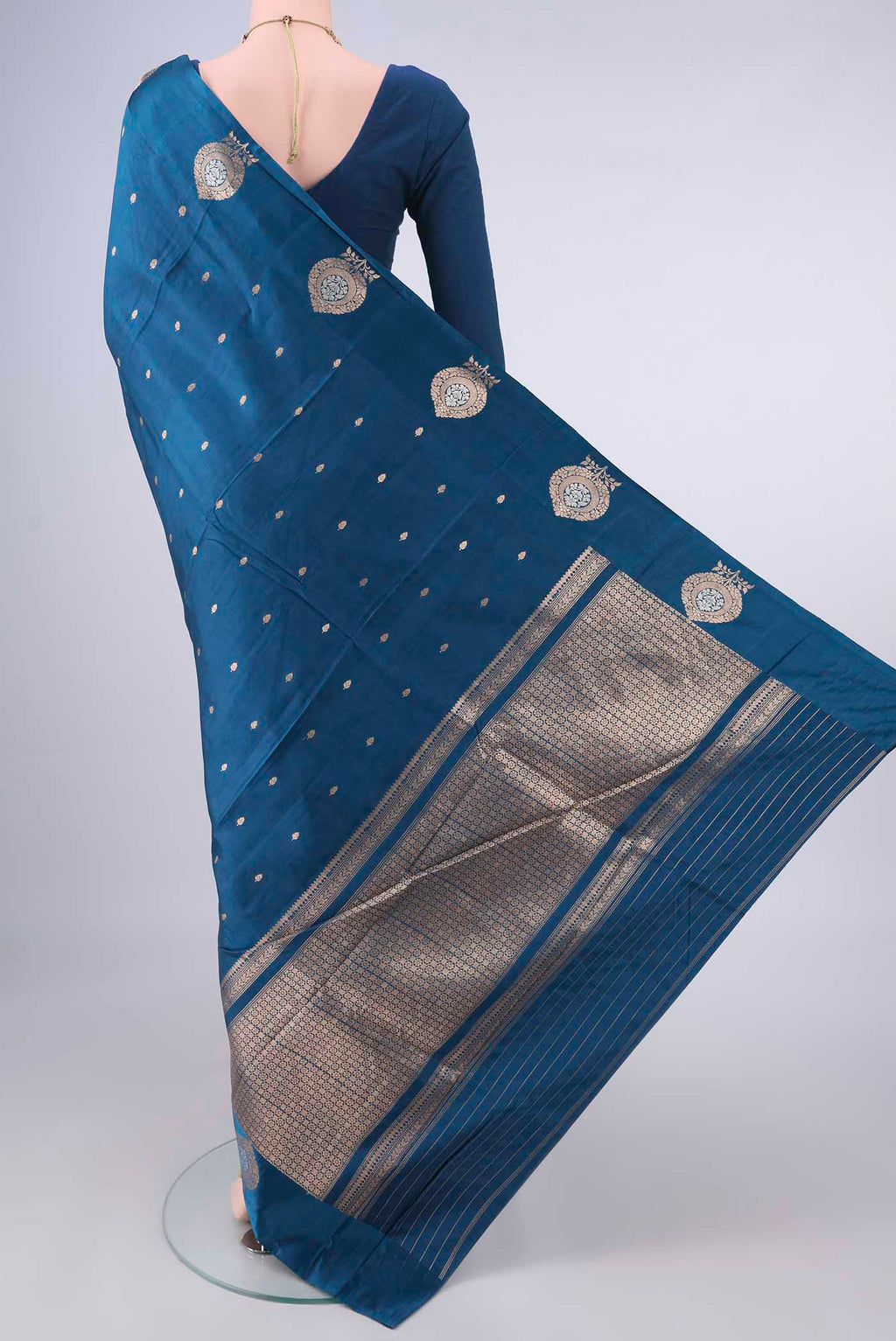 Flat view of Pure Silk Blue Banarasi Katan Saree with Zari Butta on the body and Satin Border. 