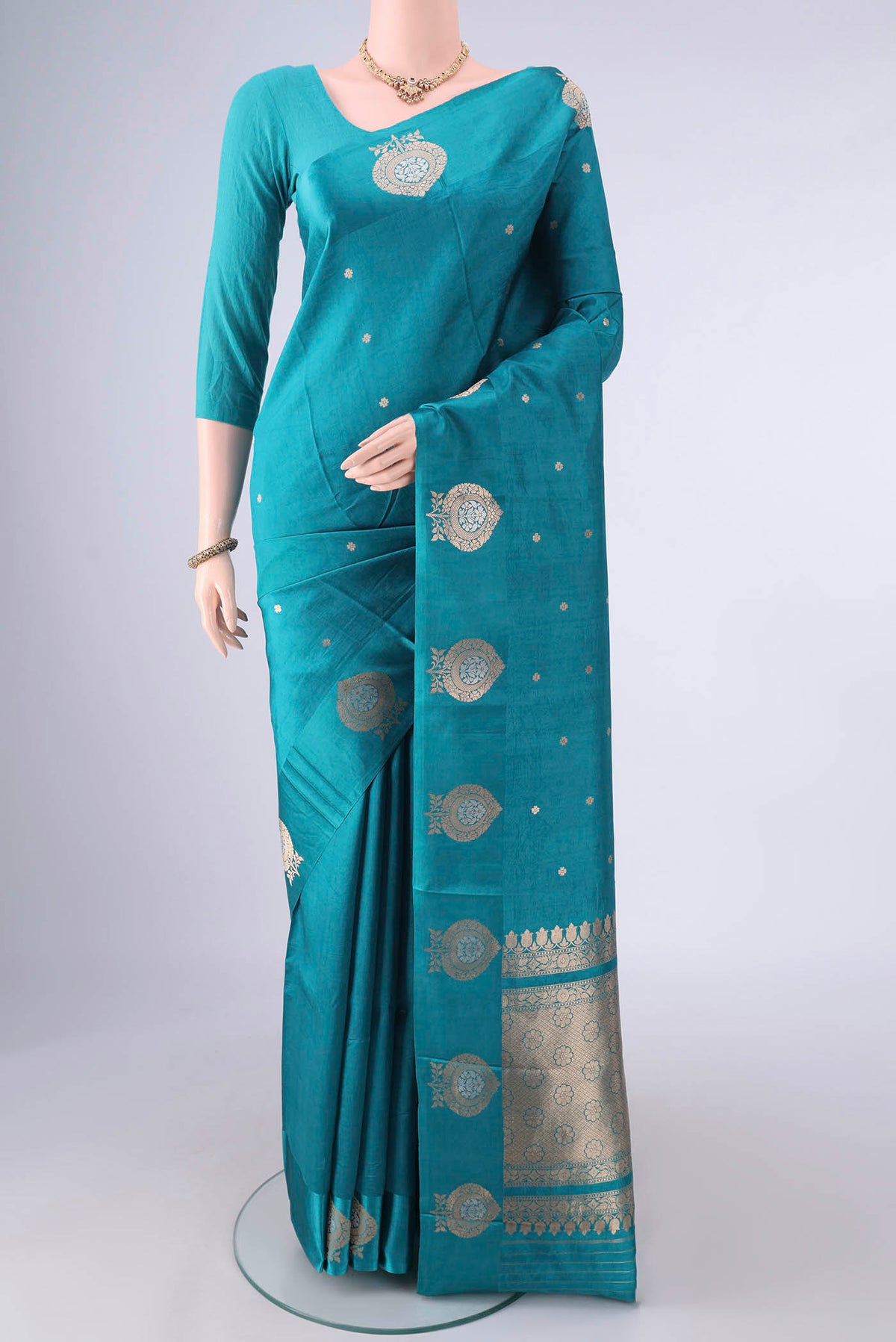 Pure Silk Sea Green Banarasi Katan Saree with Zari Butta on the body and Satin Border.  displayed on a mannequin