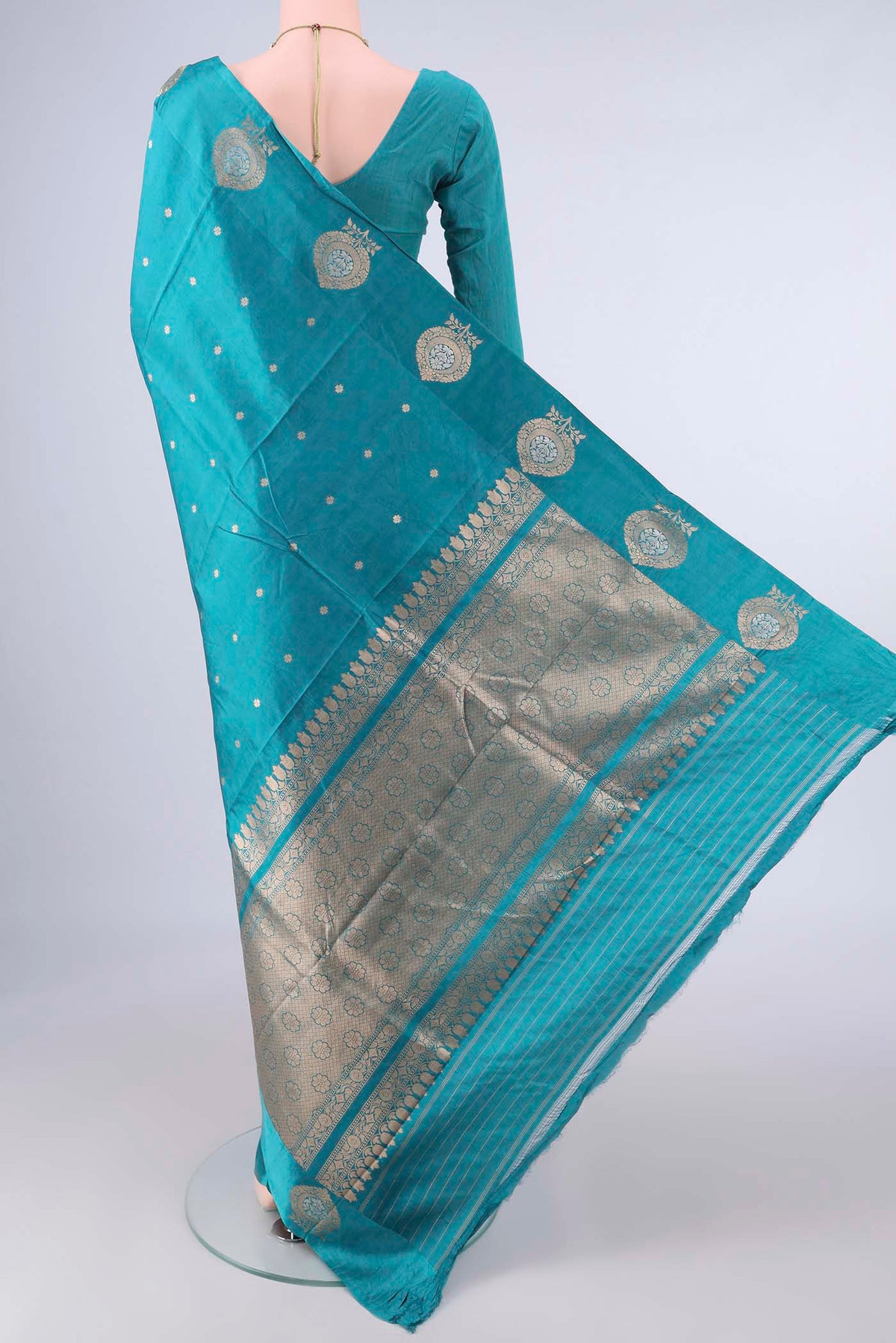 Flat view of Pure Silk Sea Green Banarasi Katan Saree with Zari Butta on the body and Satin Border. 