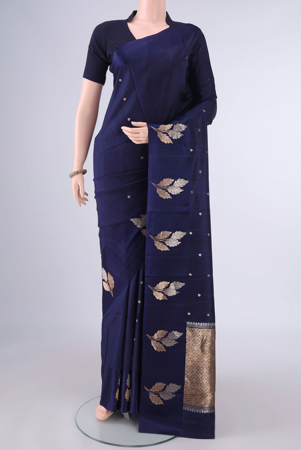 Pure Silk Navy Blue Banarasi Katan Saree with Zari Butta on the body and Satin Border.  displayed on a mannequin