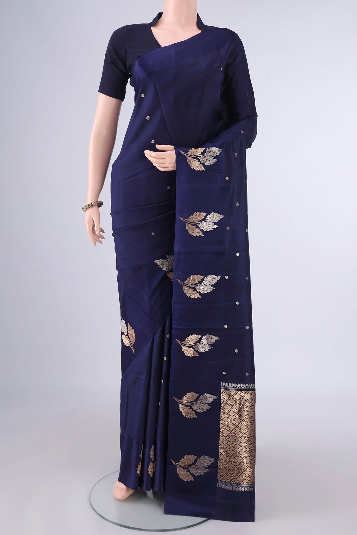 Pure Silk Navy Blue Banarasi Katan Saree with Zari Butta on the body and Satin Border.  displayed on a mannequin