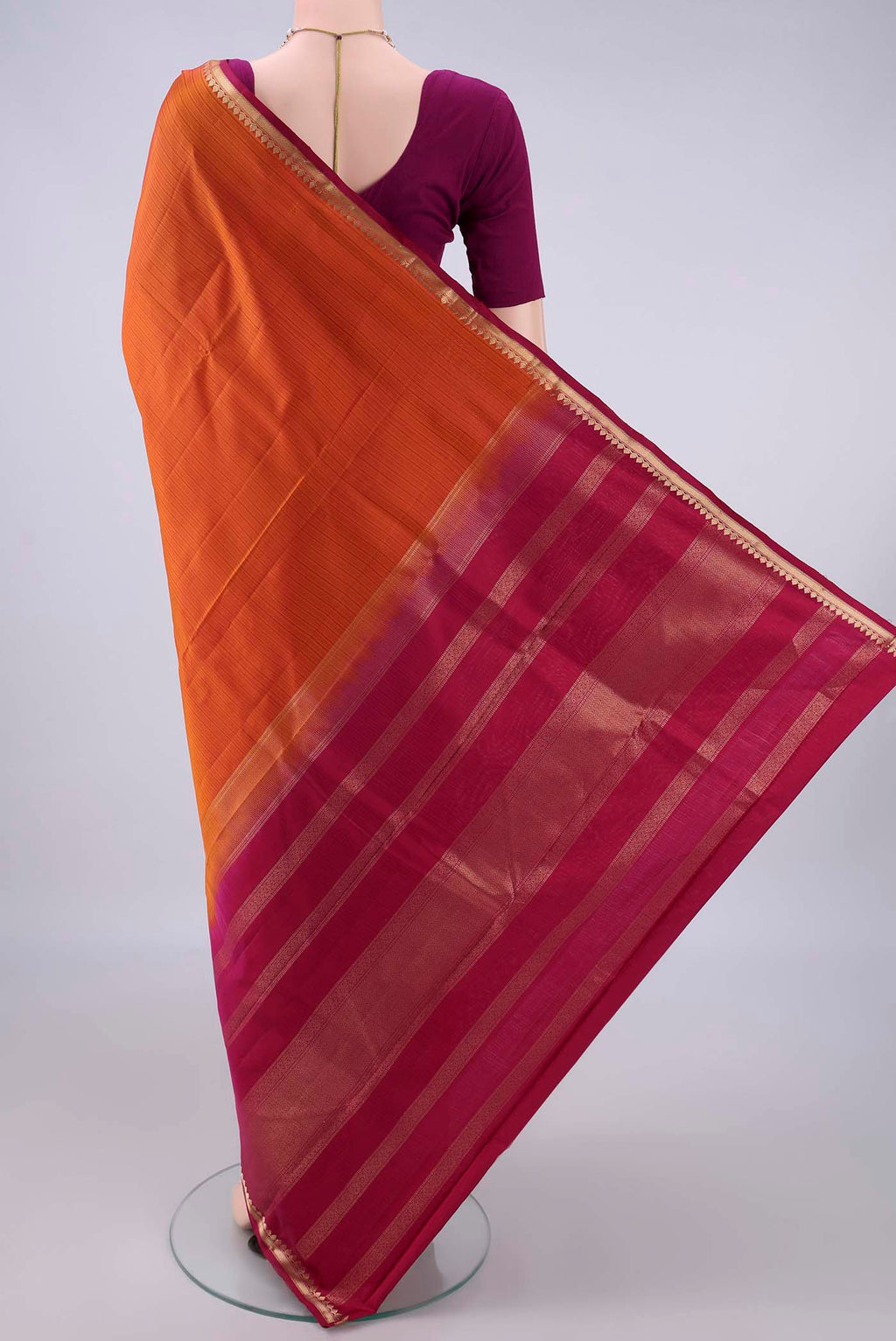 Flat view of Pure Silk Orange Kanjivaram Saree with Stripes on the body and Zari Border. 