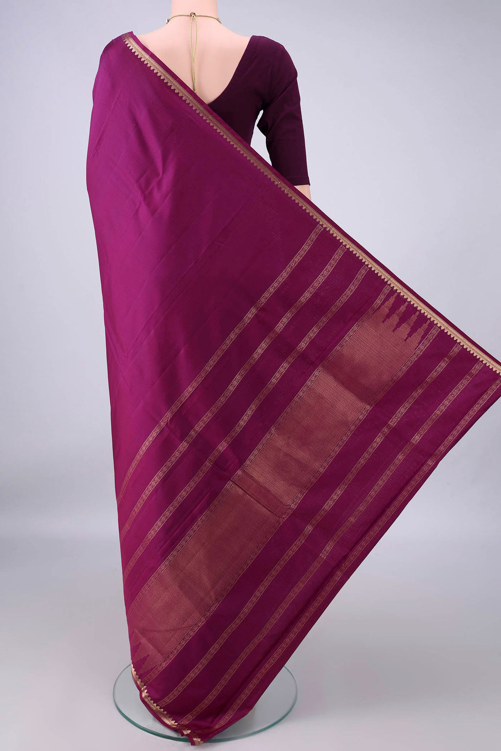 Flat view of Pure Silk Magenta Kanjivaram Saree with Plain Body and Zari Border. 