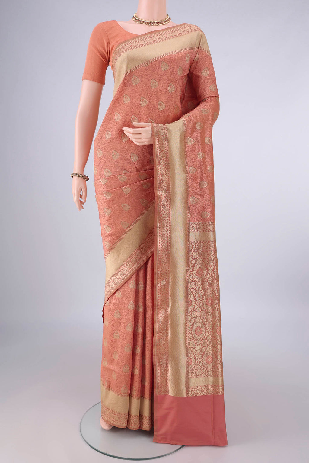 Pure Silk Peach Banarasi Saree with Jacquard With Zari Butta on the body and Zari And Thread Border.  displayed on a mannequin