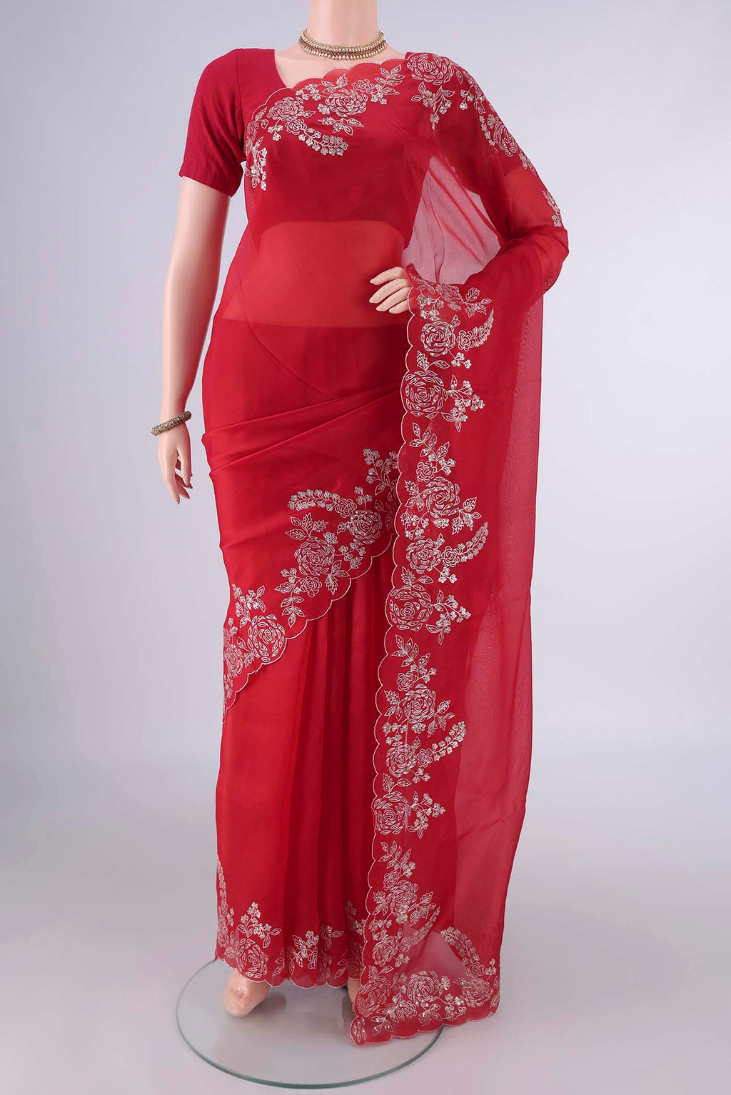 Deep Red Organza Saree with Plain Body and Embroidery Border.  displayed on a mannequin