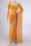 Yellow Organza Saree with Embroidery on the body and Embroidery Border.  displayed on a mannequin