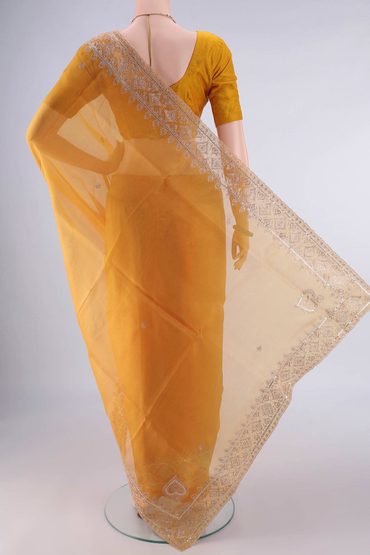 Flat view of Yellow Organza Saree with Embroidery on the body and Embroidery Border. 