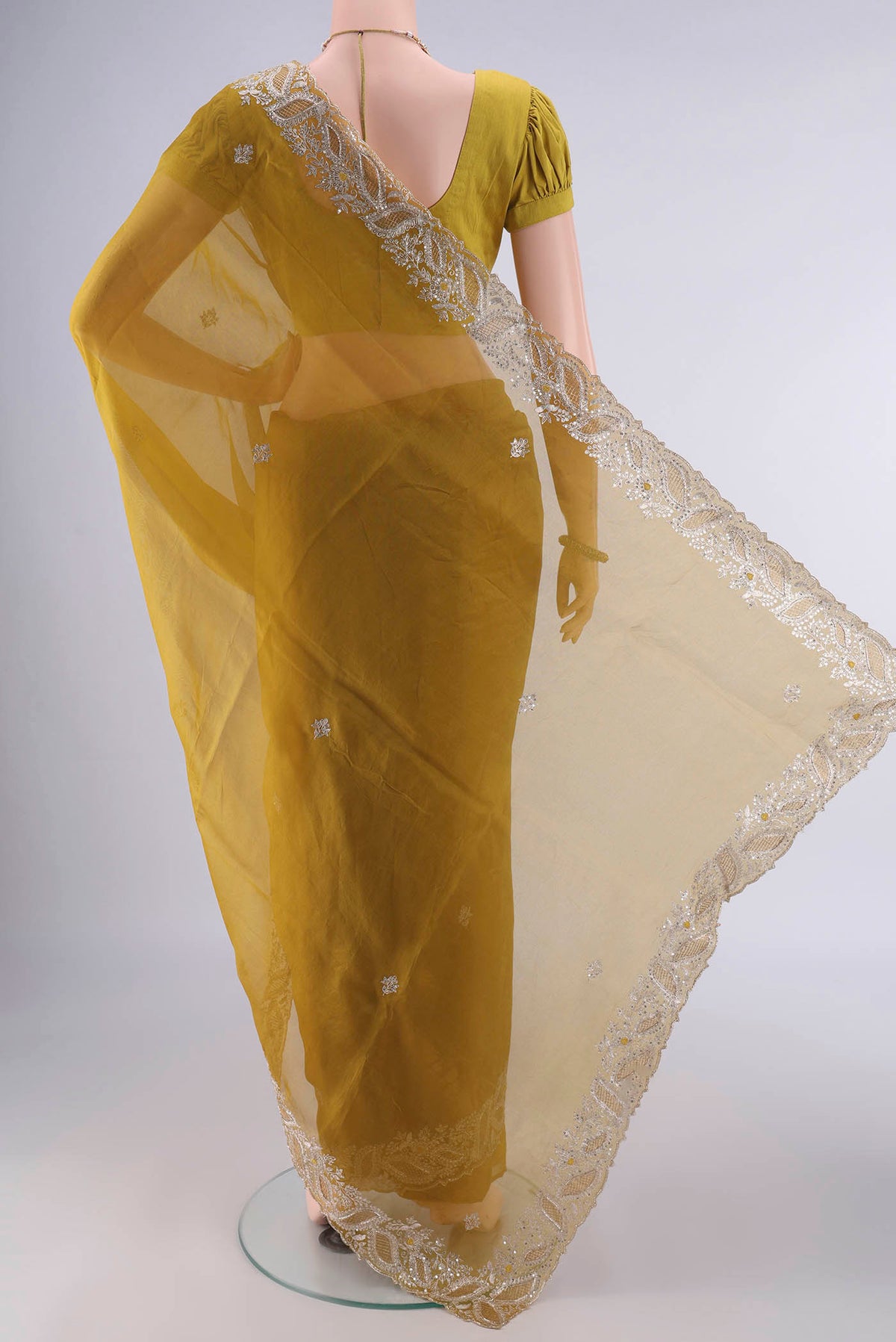 Flat view of Mehandi Green Organza Saree with Embroidery on the body and Embroidery Border. 