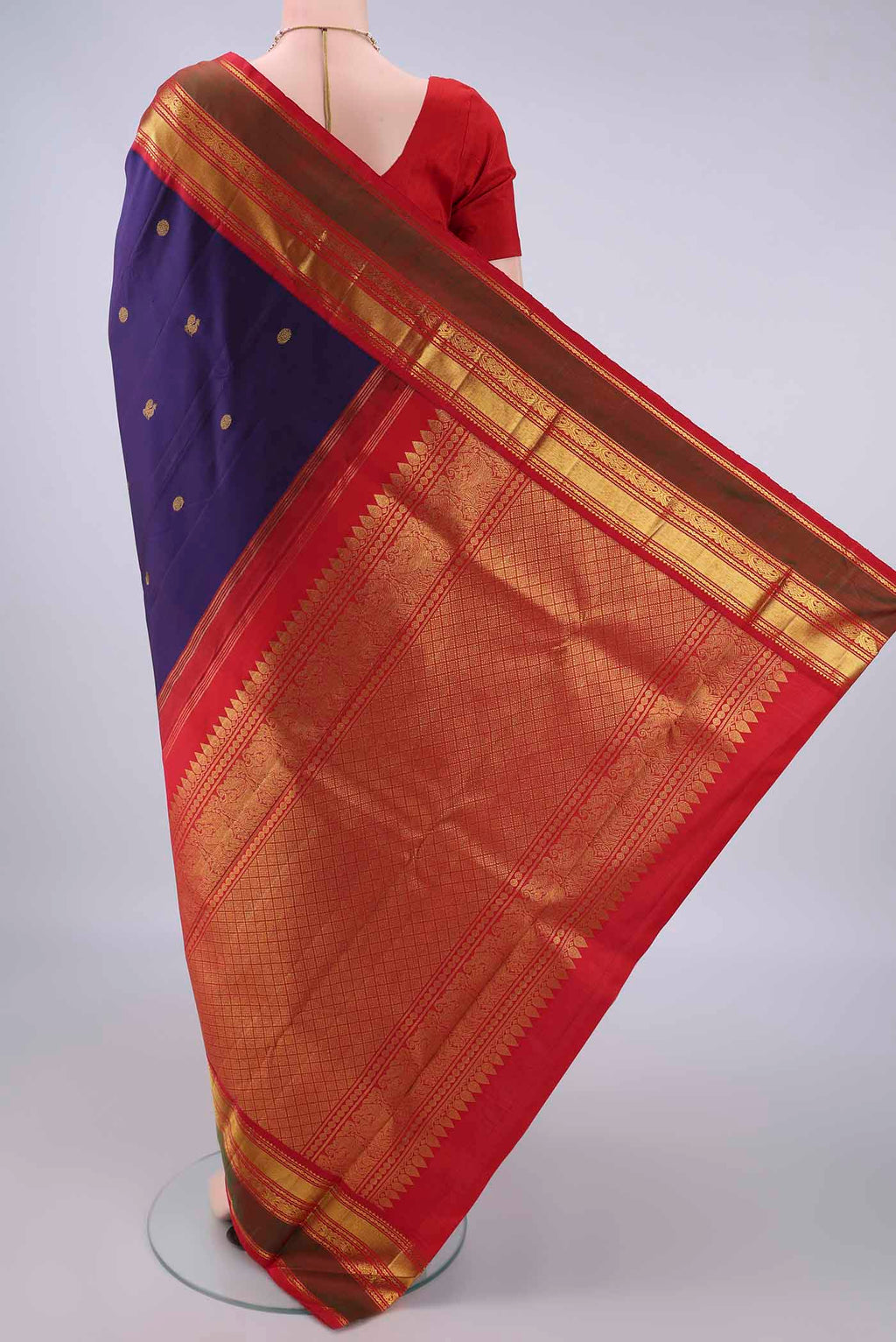 Flat view of Pure Silk Navy Blue Kanjivaram Saree with Zari Butta on the body and Zari Border. 