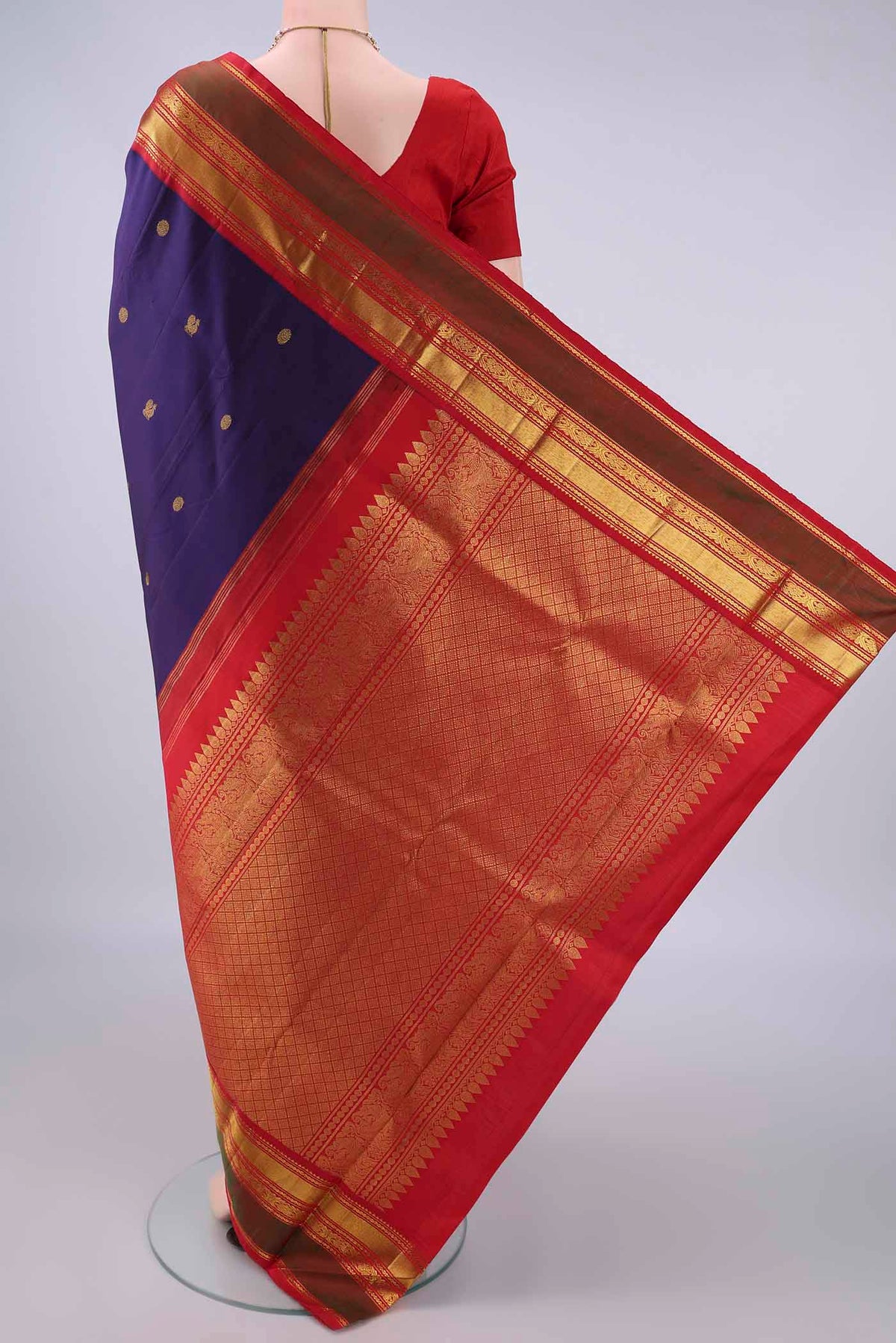 Flat view of Pure Silk Navy Blue Kanjivaram Saree with Zari Butta on the body and Zari Border. 