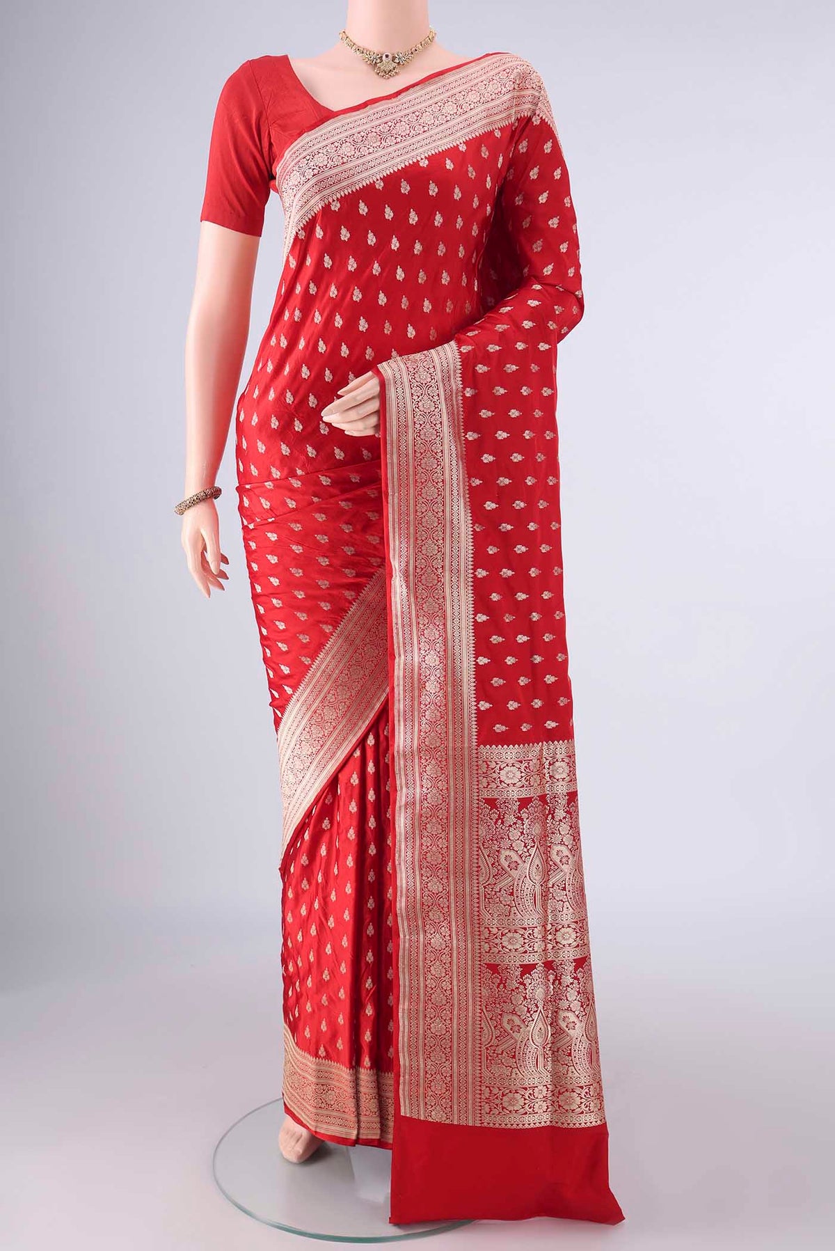 Pure Silk Red Banarasi Saree with Zari Butta on the body and Zari Border.  displayed on a mannequin