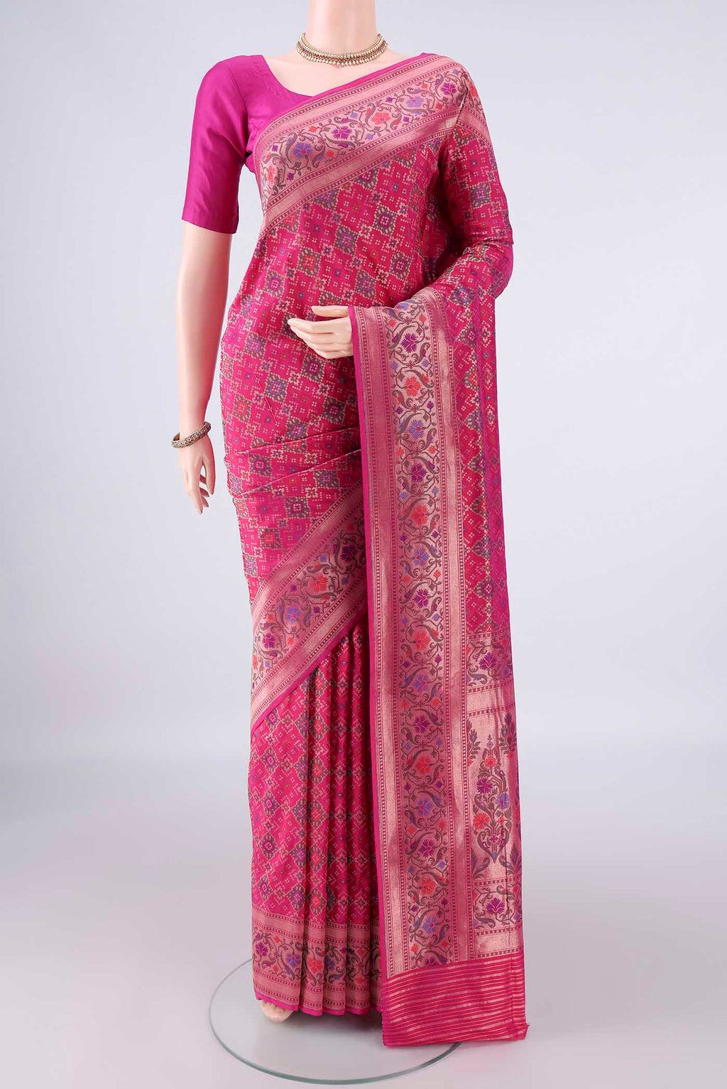 Pure Silk Rani Pink Banarasi Saree with Zari Brocade on the body and Zari Border.  displayed on a mannequin