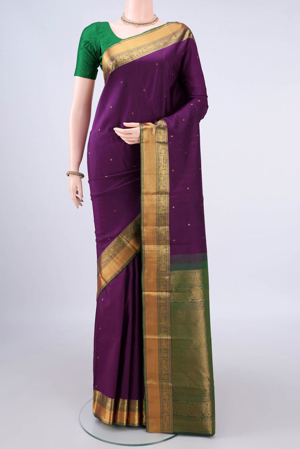 Pure Silk Purple Kanchipuram Saree with Zari Butta on the body and Zari Border.  displayed on a mannequin