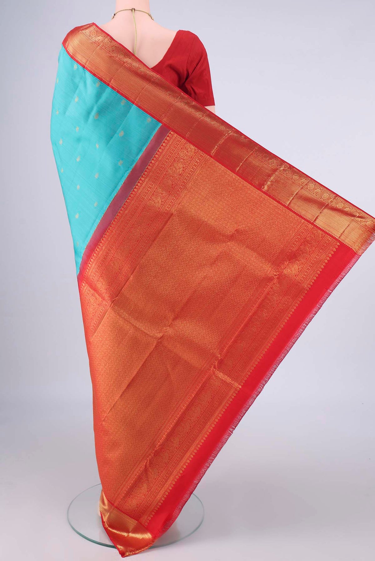 Flat view of Pure Silk Sea Green Kanjivaram Saree with Zari Butta on the body and Zari Border. 
