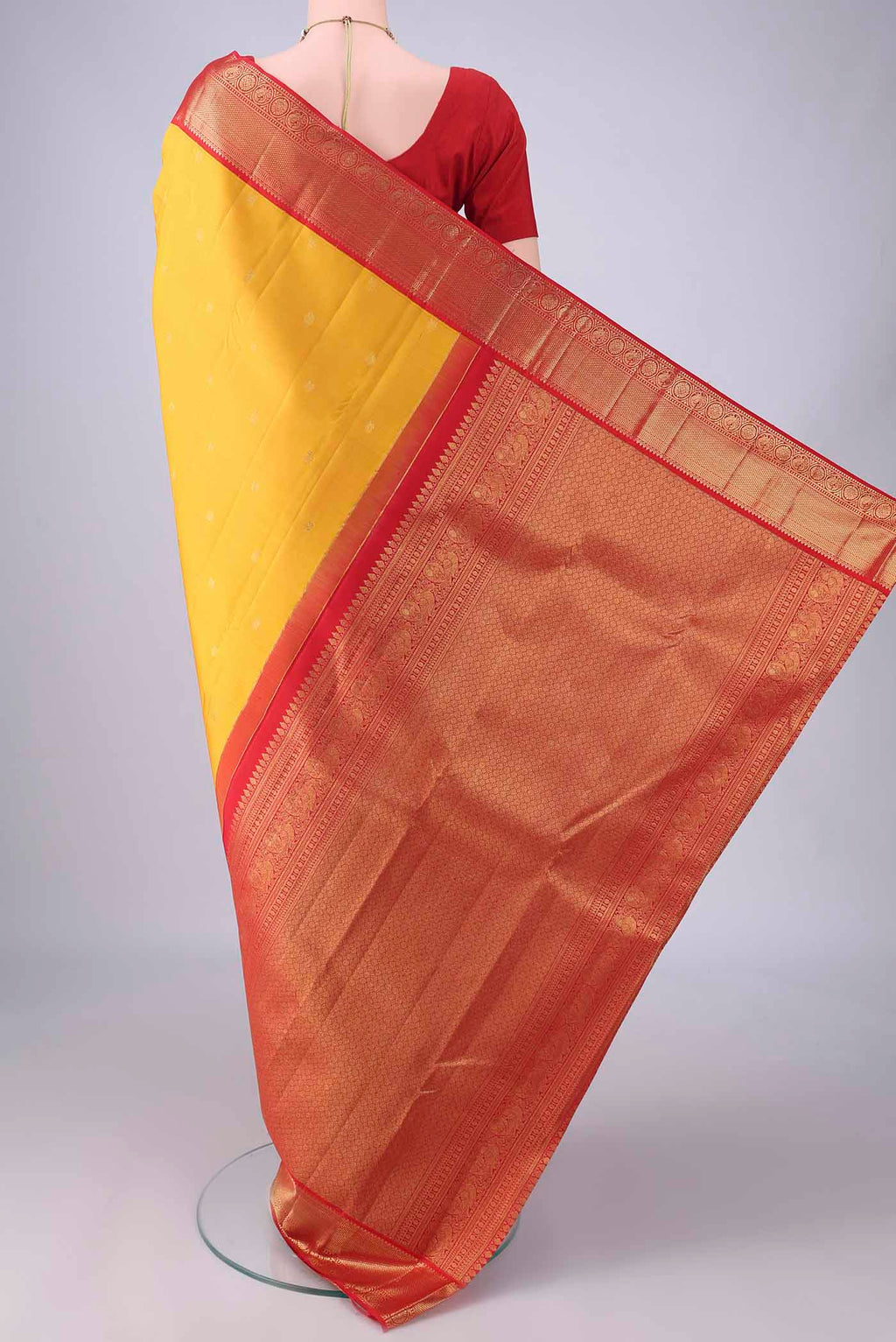 Flat view of Pure Silk Yellow Kanjivaram Saree with Zari Butta on the body and Zari Border. 